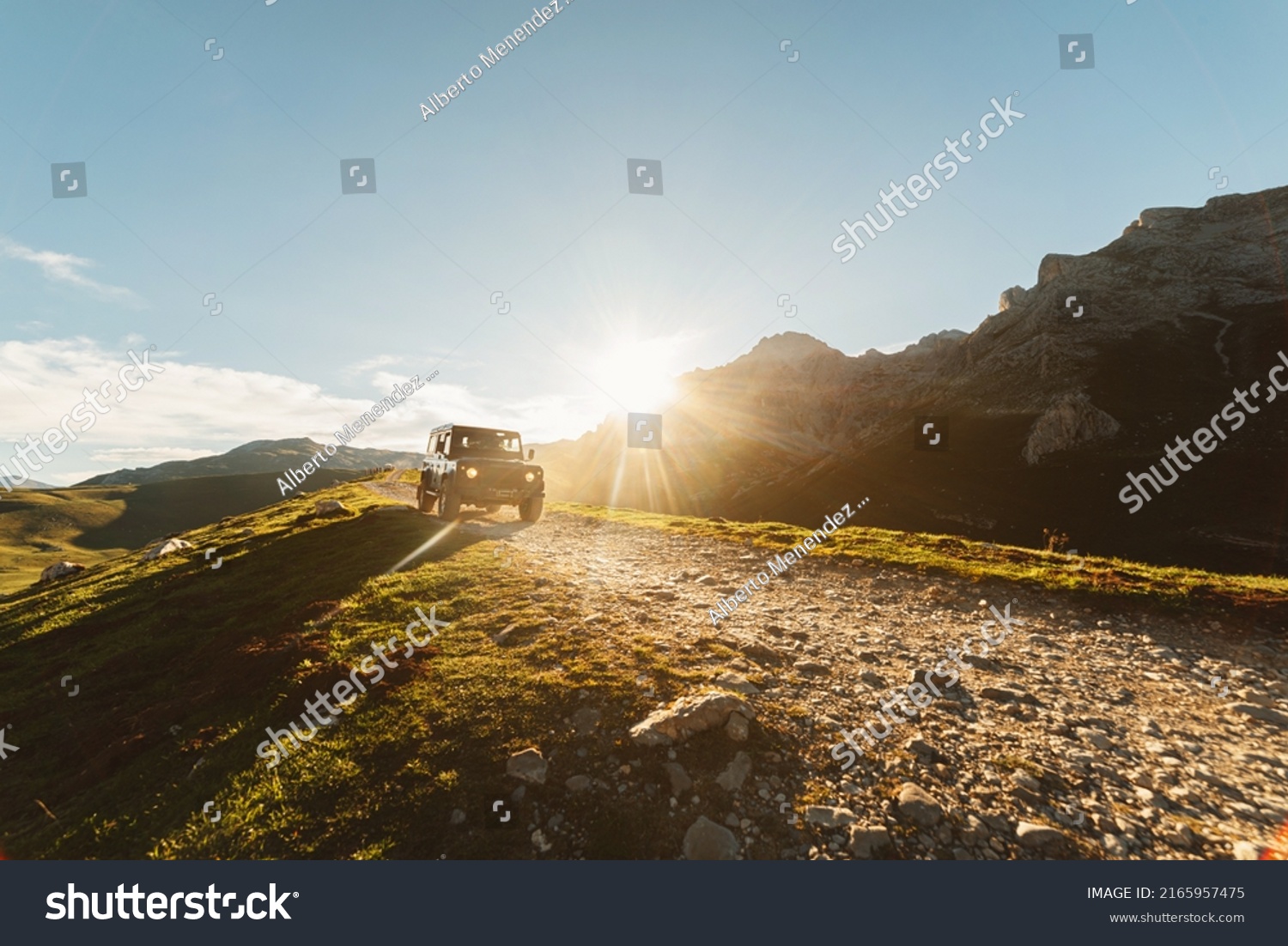 4x4 off-road car driving along a mountain track on a sunny day. car adventure trip #2165957475