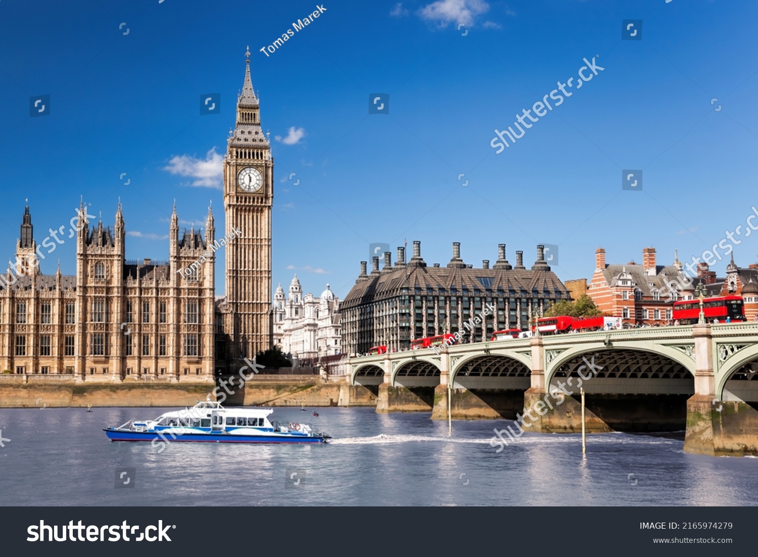 Famous Big Ben with bridge over Thames and tourboat on the river in London, England, UK #2165974279