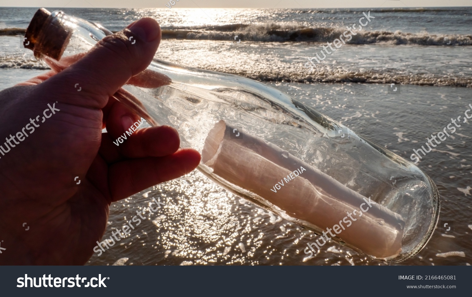 A message in a bottle washed up on the beach by waves #2166465081