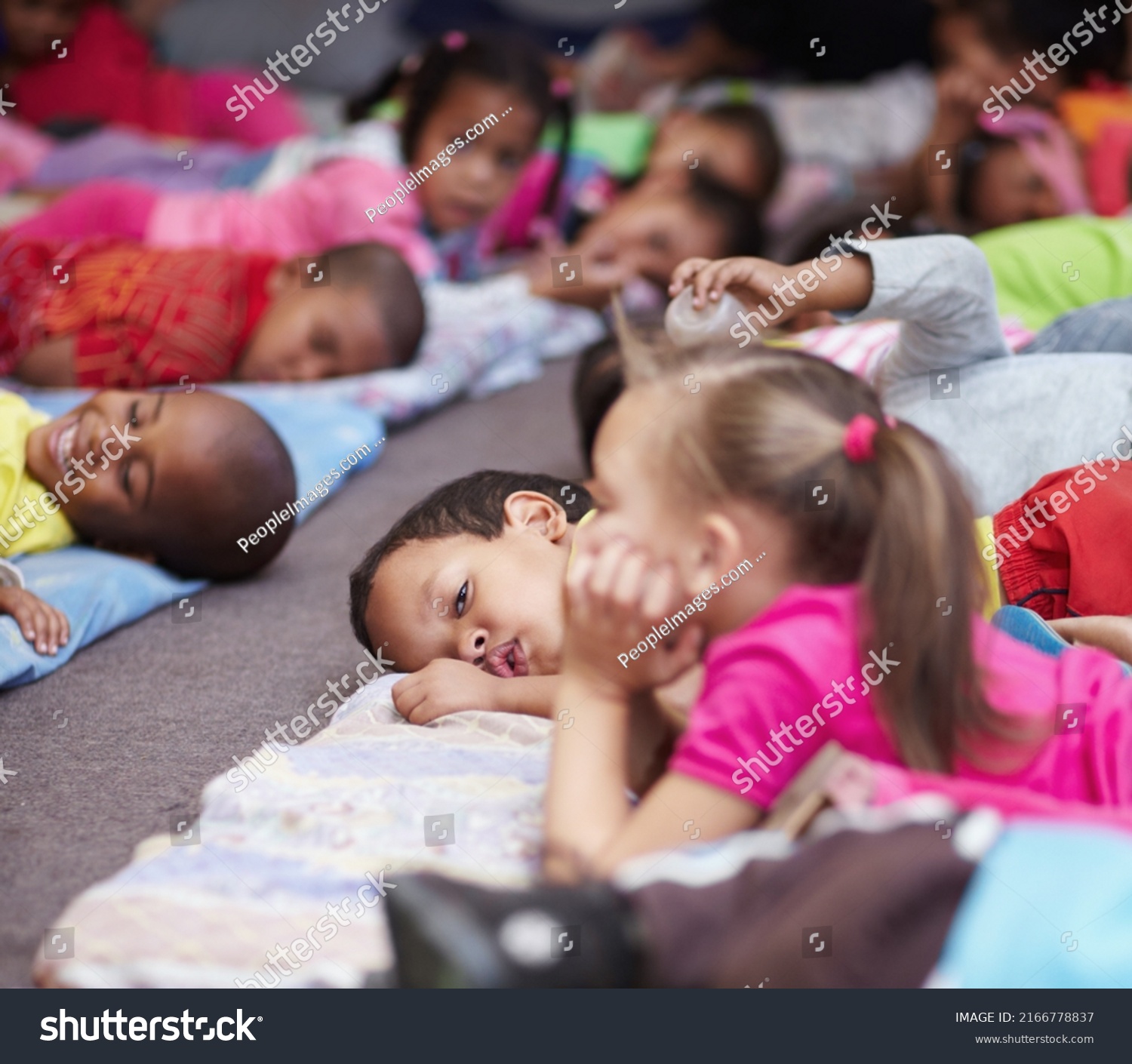 Nap-time. Preschool children all lying down and getting ready for bed. #2166778837