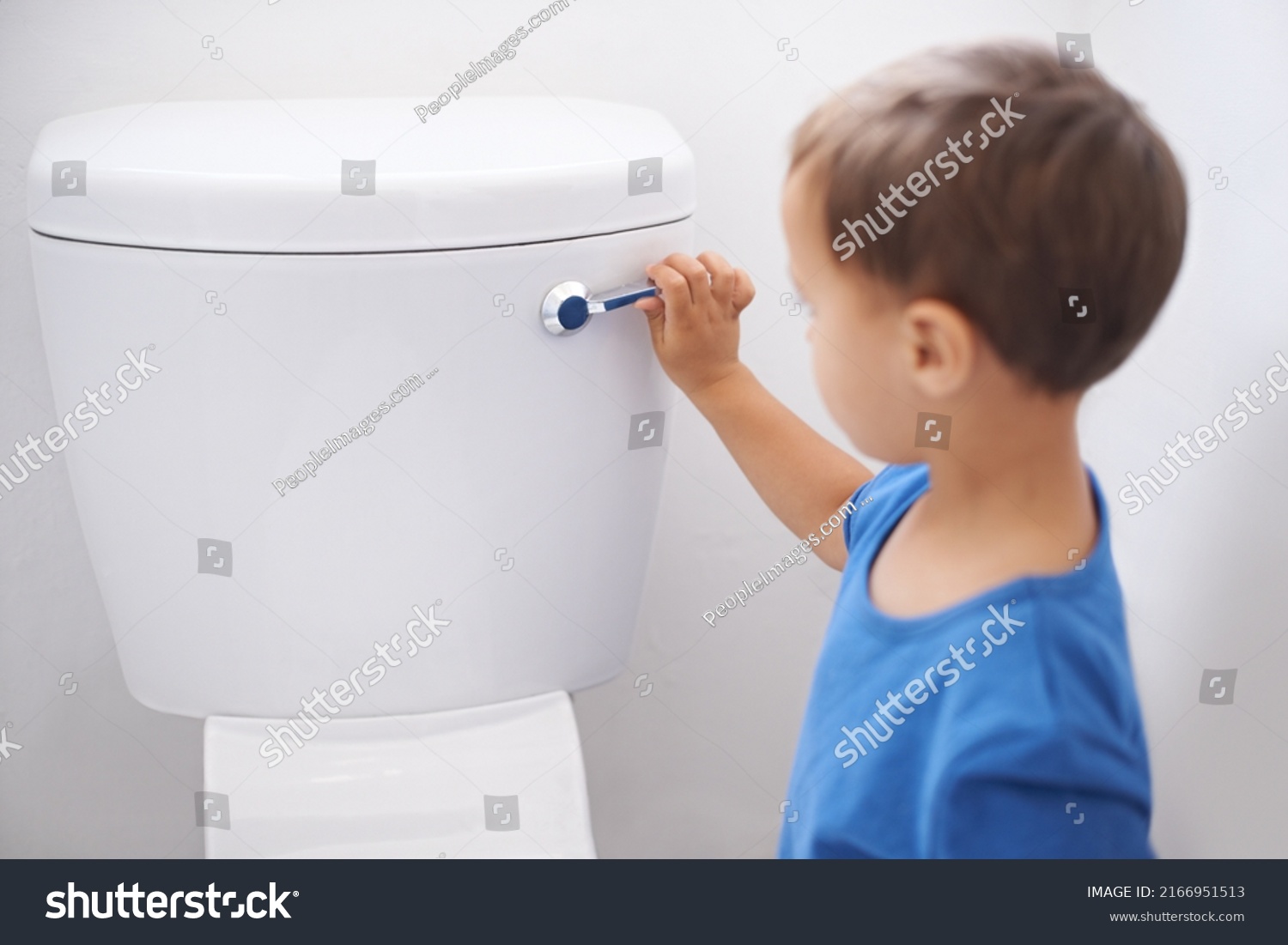 All done. Shot of a cute young boy flushing a toilet. #2166951513