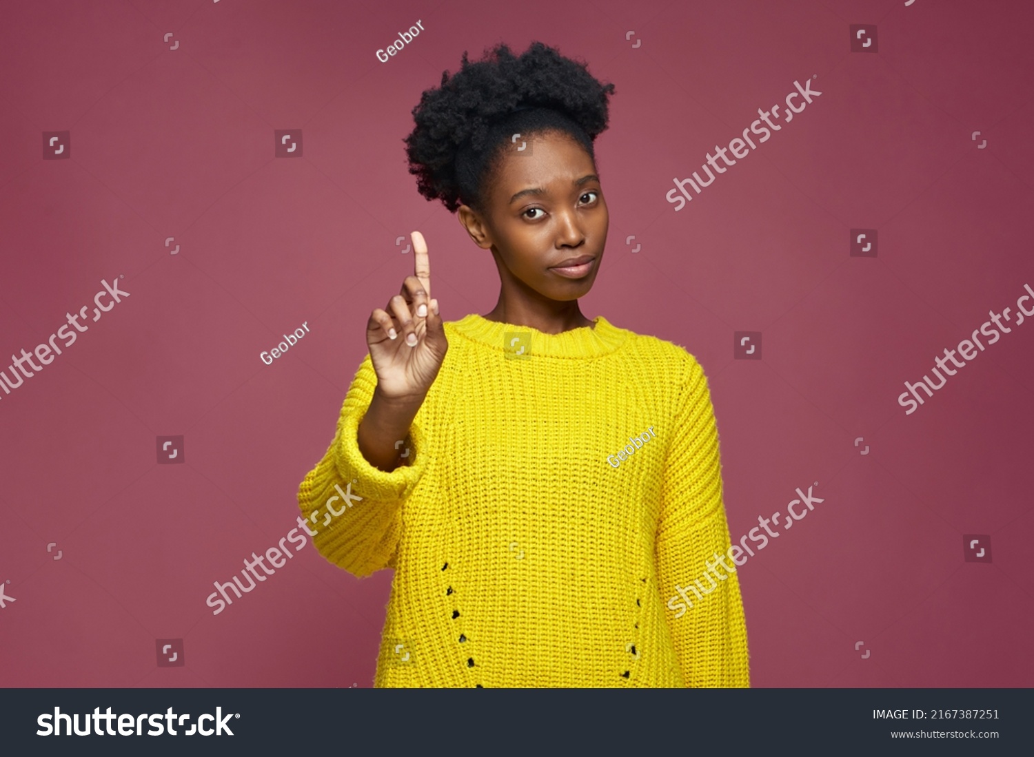 African american girl warning raised forefinger up, does admonishing gesture, giving advice to avoid danger, disapprove #2167387251