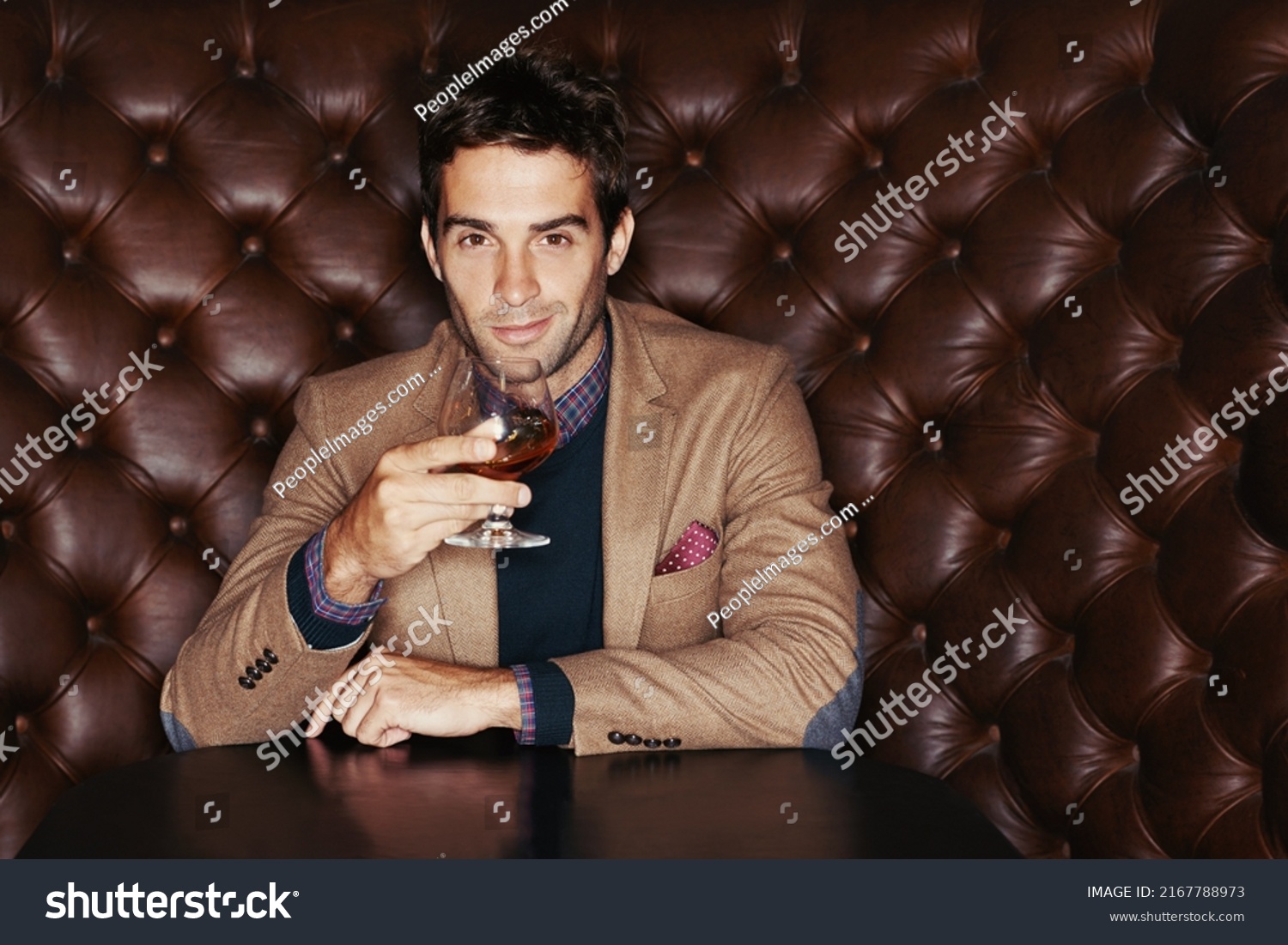 Waiting for my friends. Portrait of a handsome young man drinking in a club. #2167788973