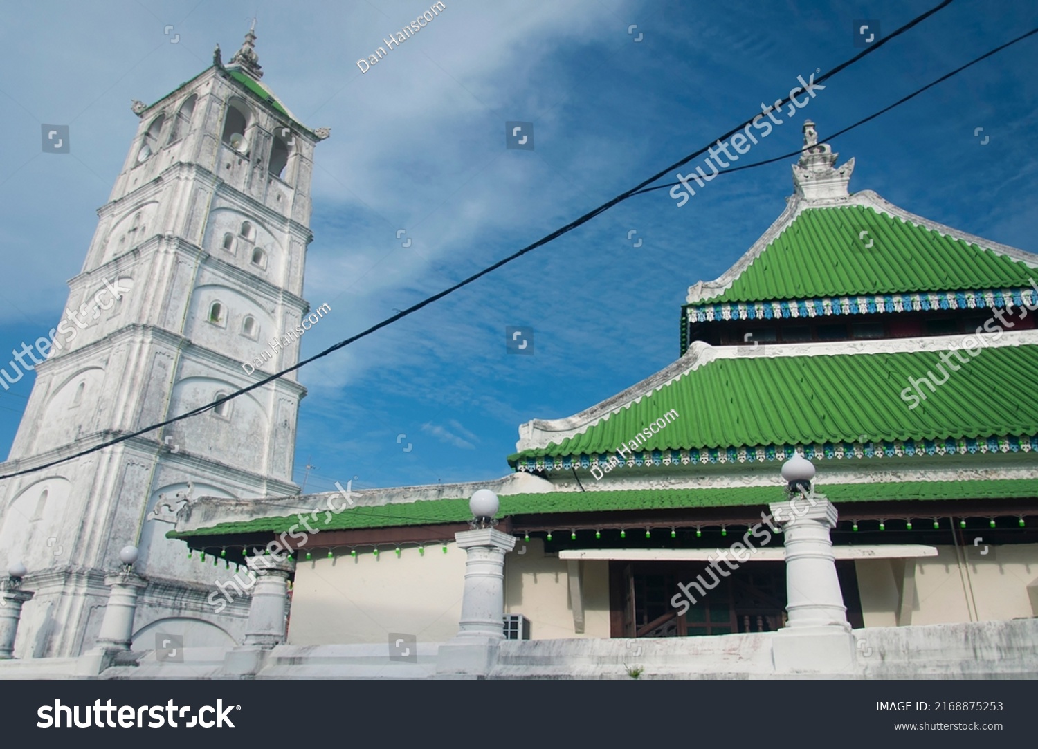 the historic weathered tower at the Kampung Kling mosque built in 1748 in the city of Malacca Malaysia on a blue sky day. #2168875253