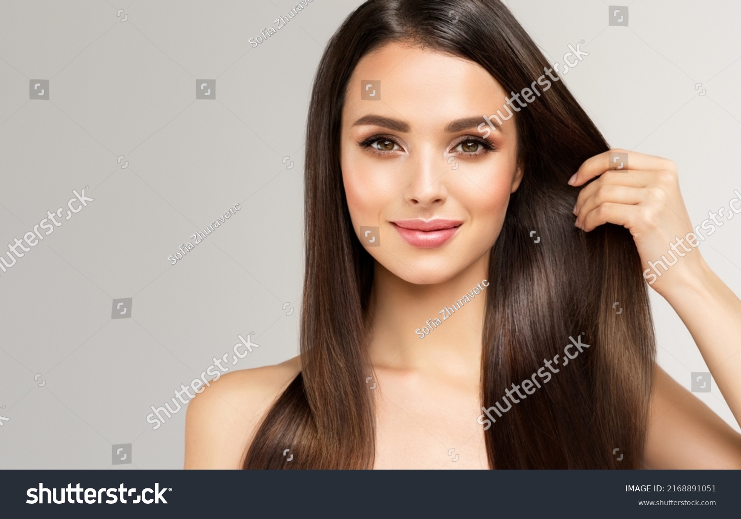 Beautiful model girl with shiny brown and straight long  hair . Keratin  straightening . Treatment, care and spa procedures. Smooth hairstyle
 #2168891051