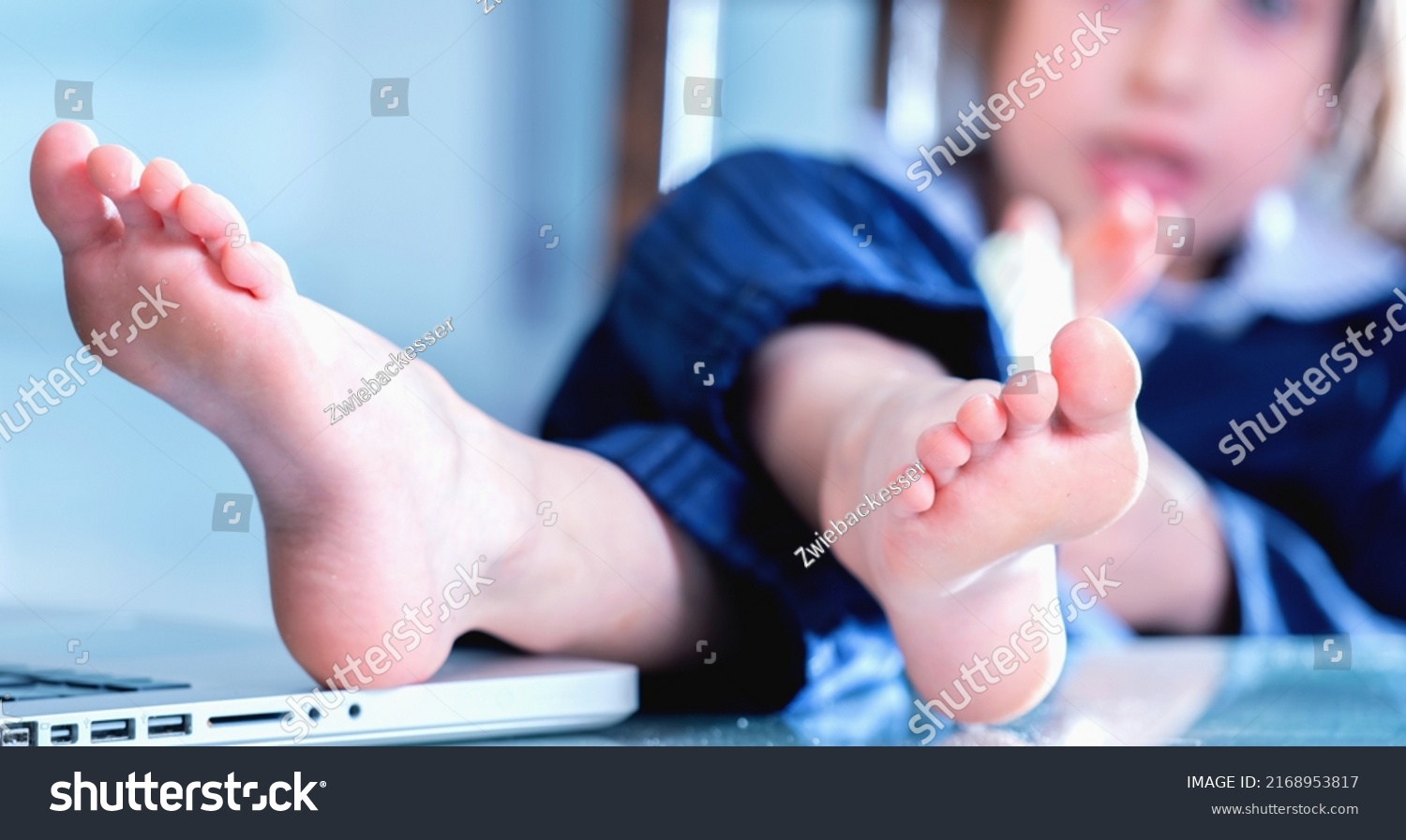 Young business girl with bare foots on the table in the office. Selective focus on foot. Horizontal image. #2168953817
