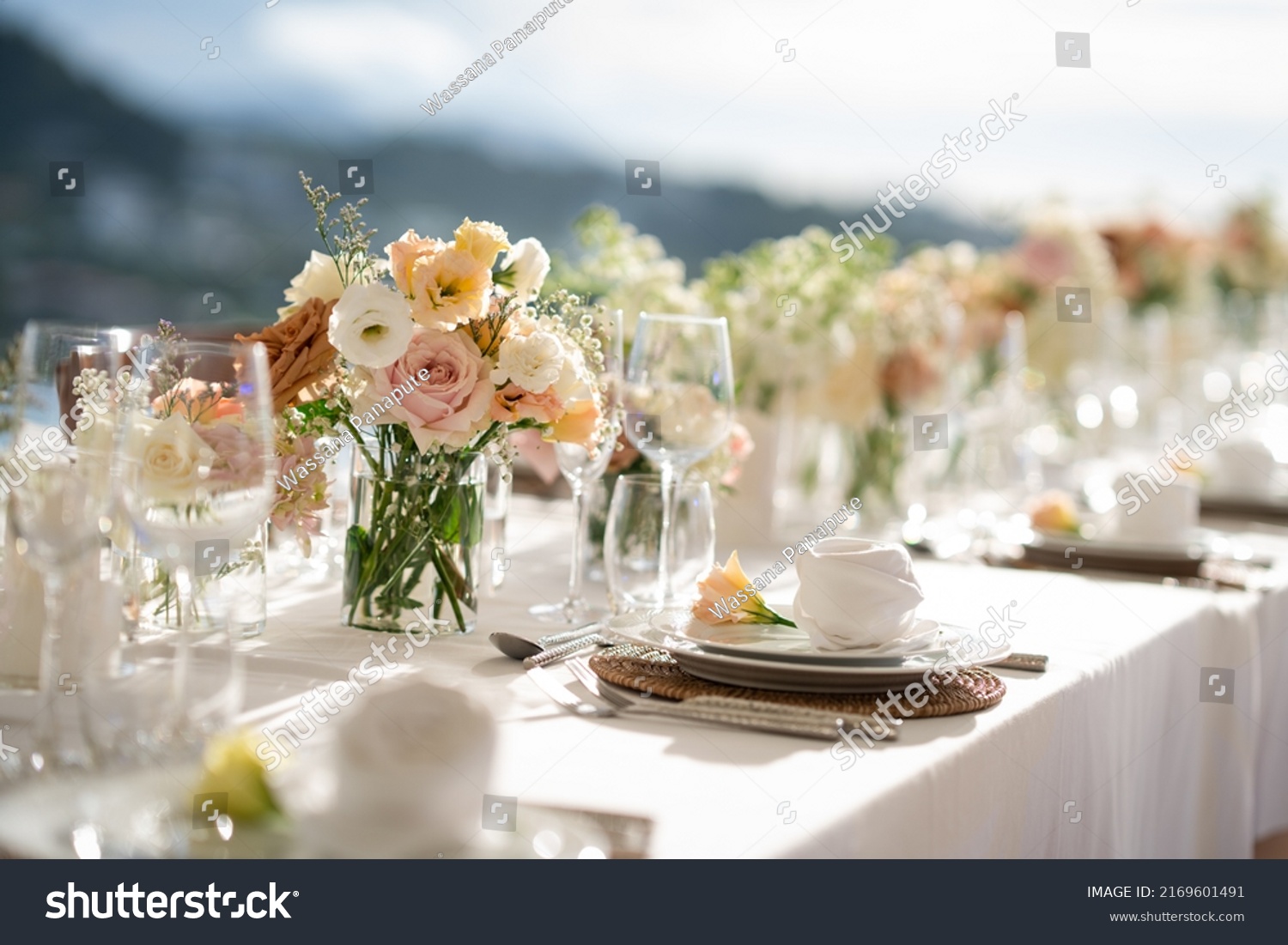 Beautiful flowers decorated on the table.Tables set for an event party or wedding reception. luxury elegant table setting dinner in a restaurant. glasses and dishes. Fancy moment fancy time. #2169601491