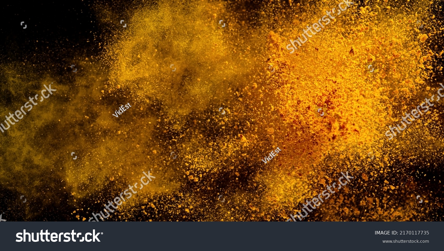 Explosion, Splashes of turmeric on a black background. India Seasoning. The orange powder of the turmeric root. Explosion of powder #2170117735