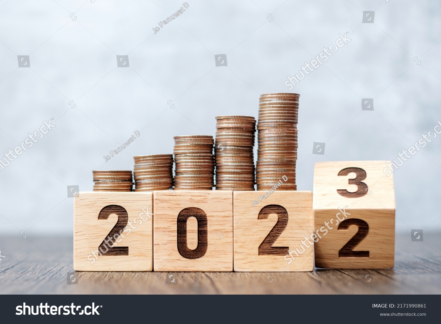 flipping 2022 to 2023 year block with Coins stack. Money, Budget, tax, investment, financial, savings and New Year Resolution concepts #2171990861