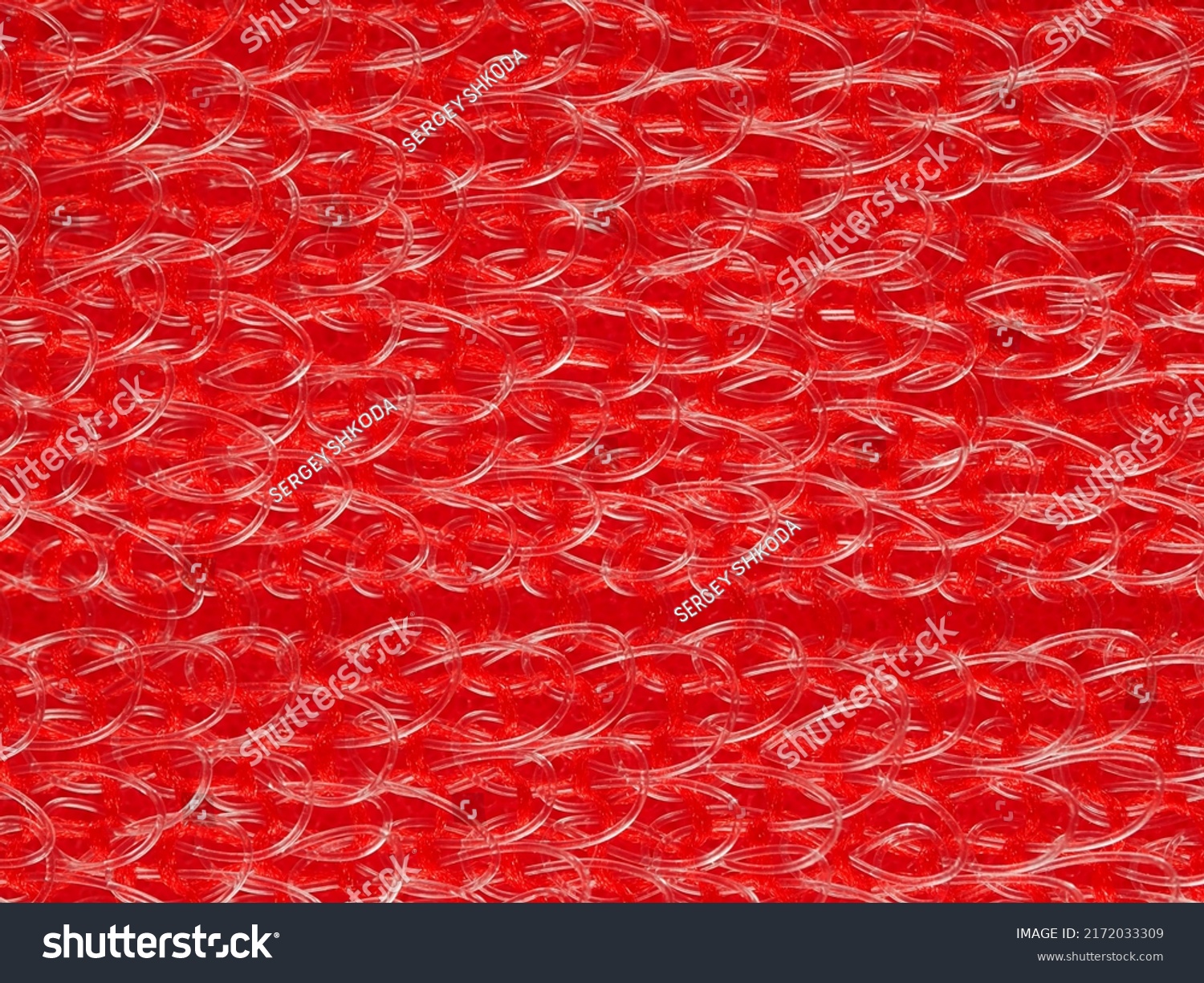 close up, background, texture, large horizontal banner. heterogeneous surface structure bright saturated red sponge for washing dishes, kitchen, bath. full depth of field. high resolution photo #2172033309