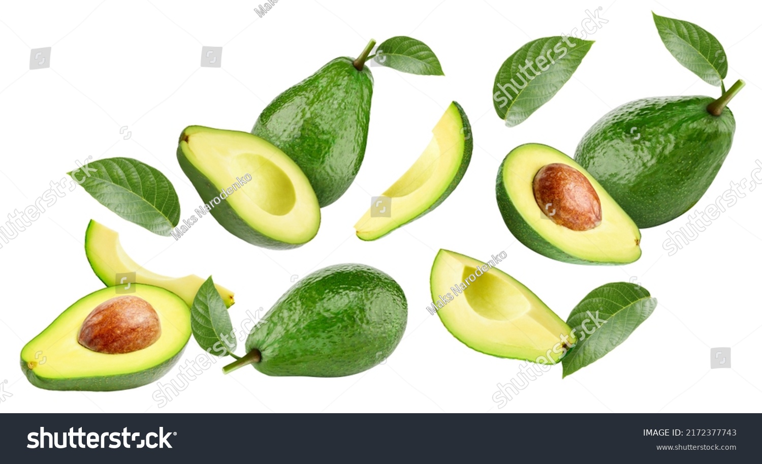 Flying in air Avocado whole and cut in half with leaf isolated on white background. Levitation Avocado Clipping Path. #2172377743