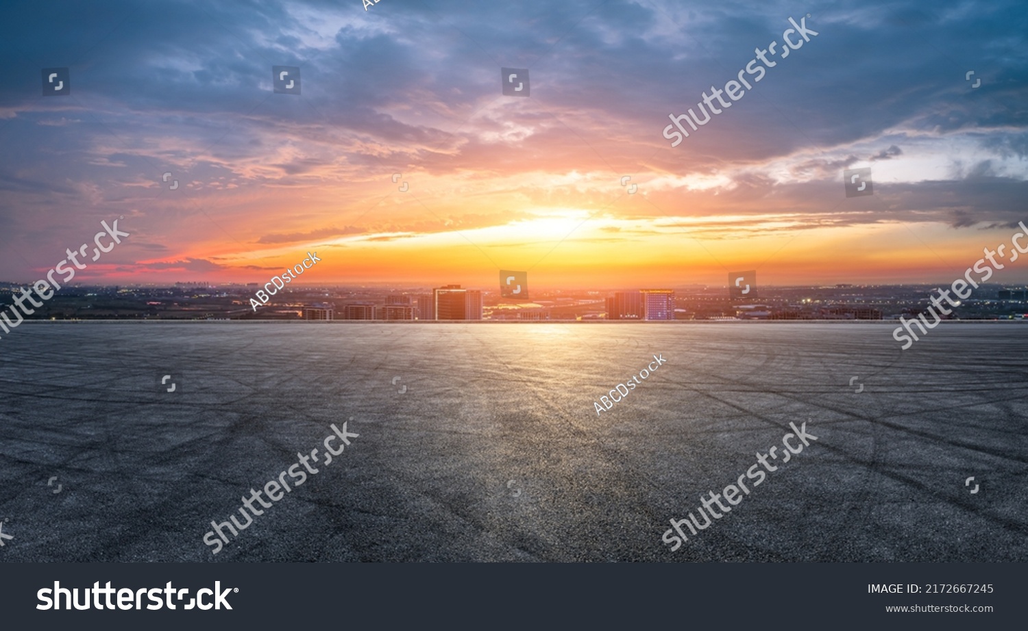 Empty asphalt road and modern city skyline with building scenery at sunset. high angle view. #2172667245