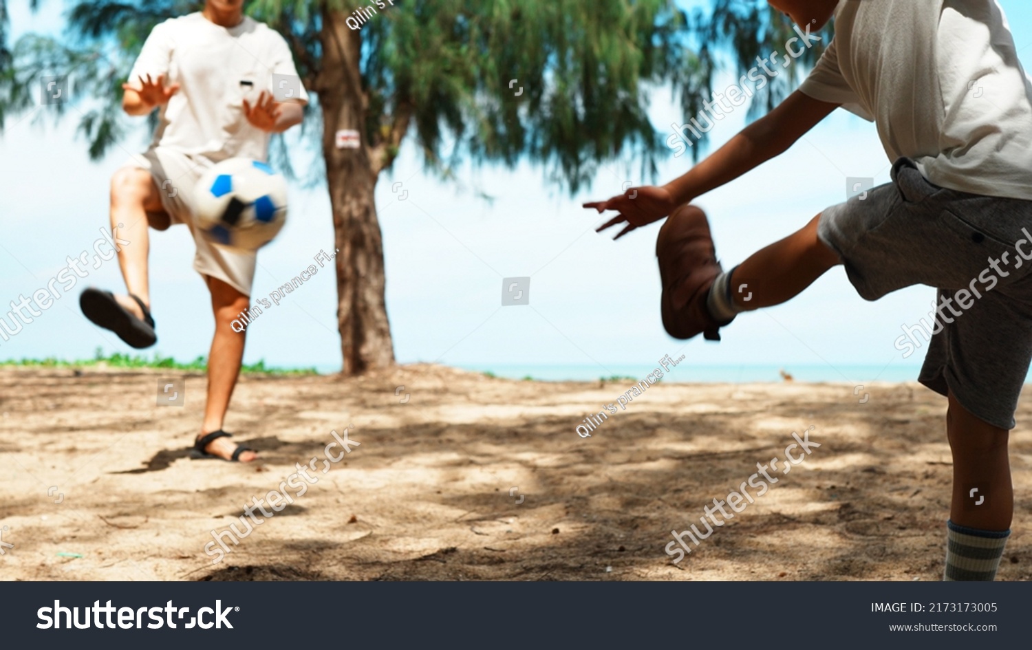 Father and son playing football on the outside summer beach relaxing fun and enjoy life, Happy family with sports concept. #2173173005