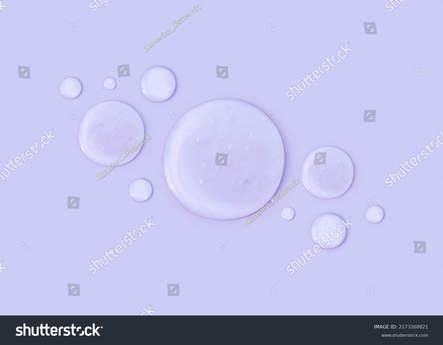 round drops of transparent gel serum on pastel background #2173268821
