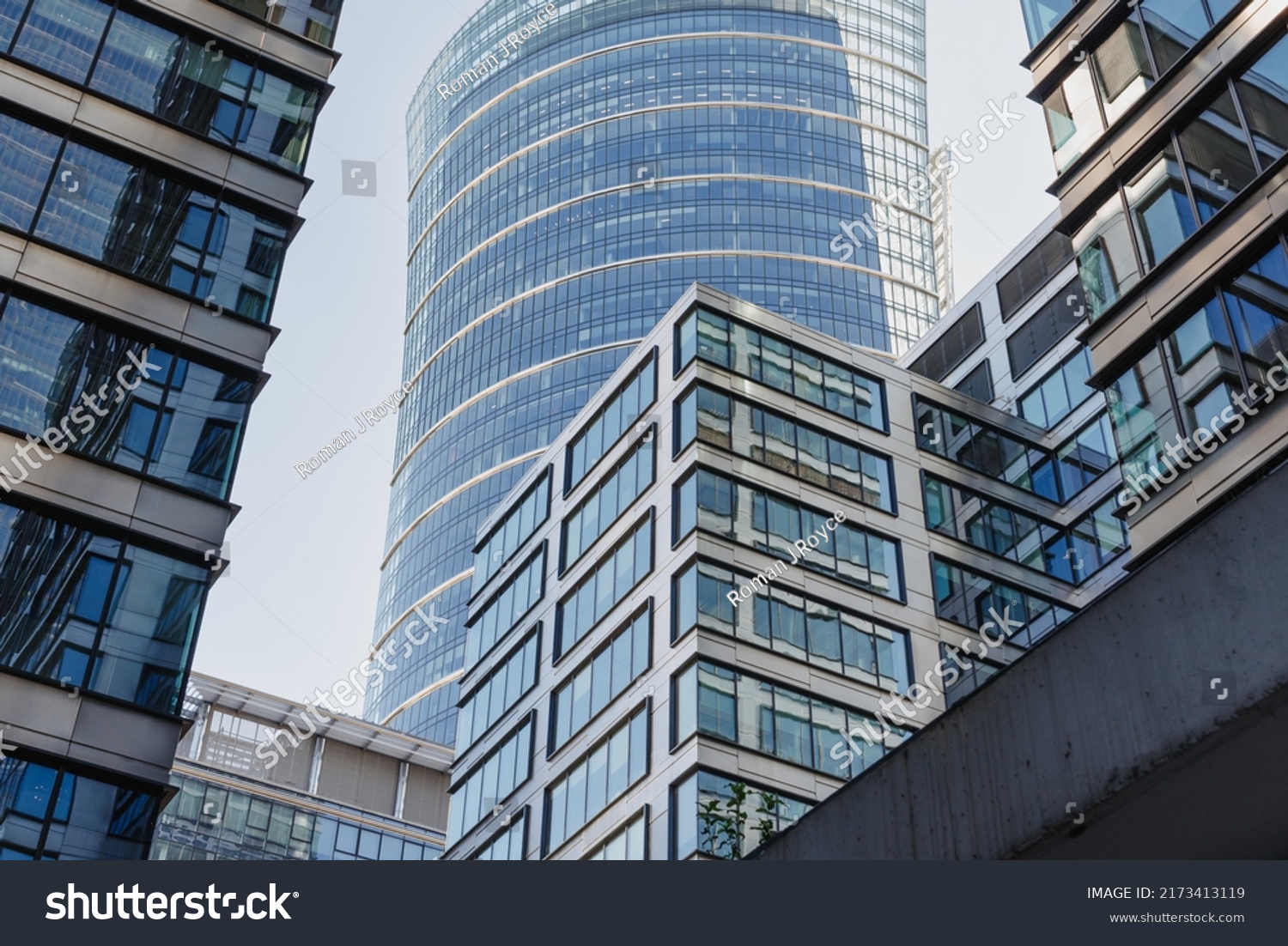 The view of the close constructed modern office buildings in the financial district. Glass towers in downtown of the city. A cluster of tall buildings. #2173413119