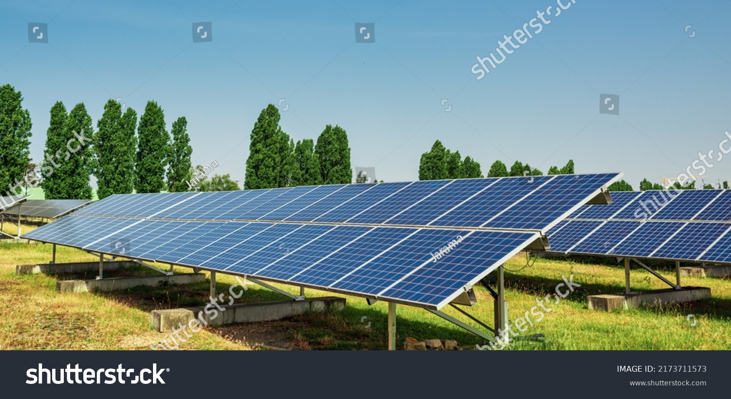 Solar panel of a solar park. Photovoltaic modules of a Solar energy power plant producing sustainable energy to prevent climate change. #2173711573
