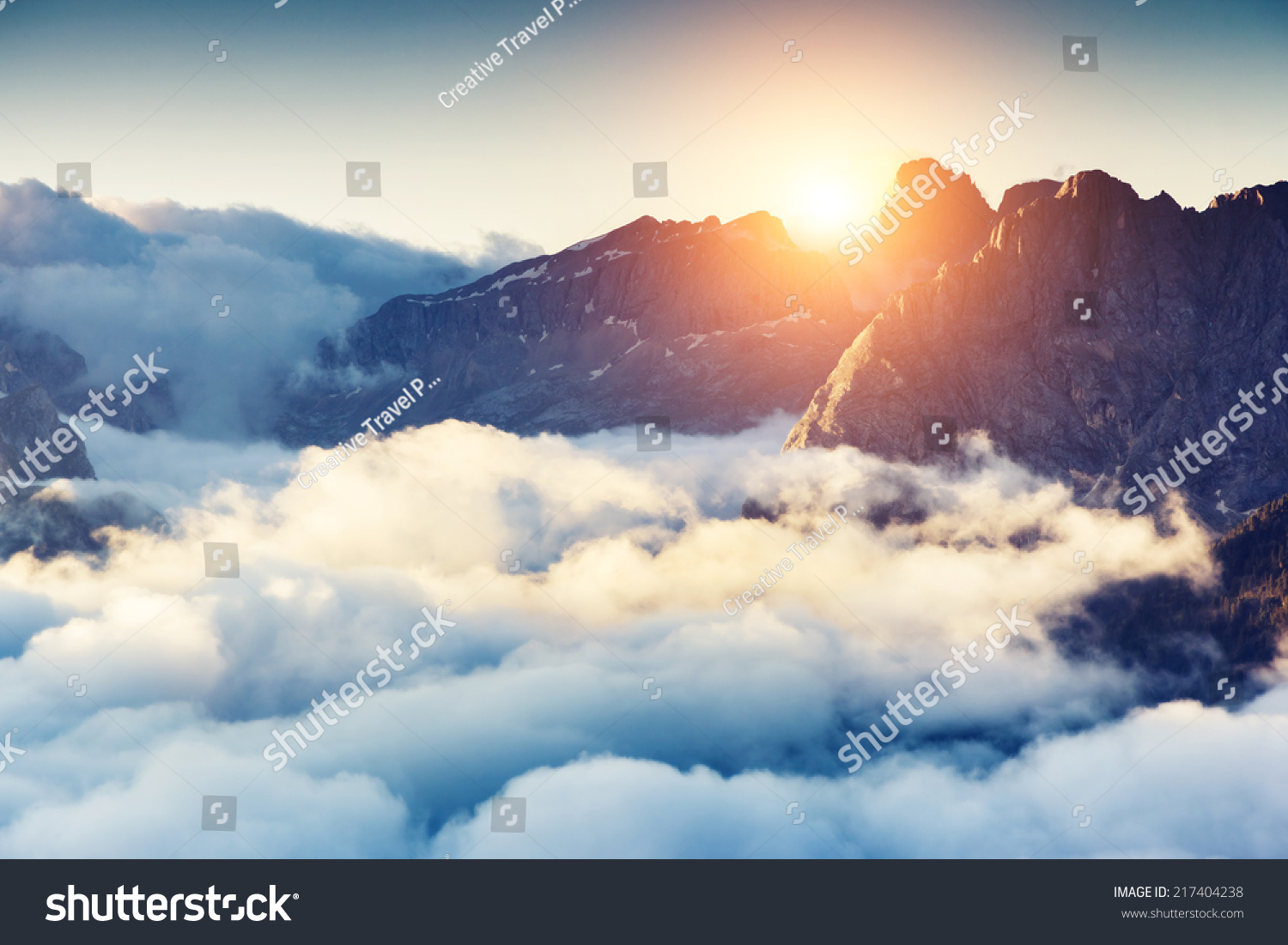 Great view of the foggy Val di Fassa valley with passo Sella. National Park. Dolomites, South Tyrol. Location Canazei, Campitello, Mazzin. Italy, Europe. Dramatic scene. Beauty world. #217404238