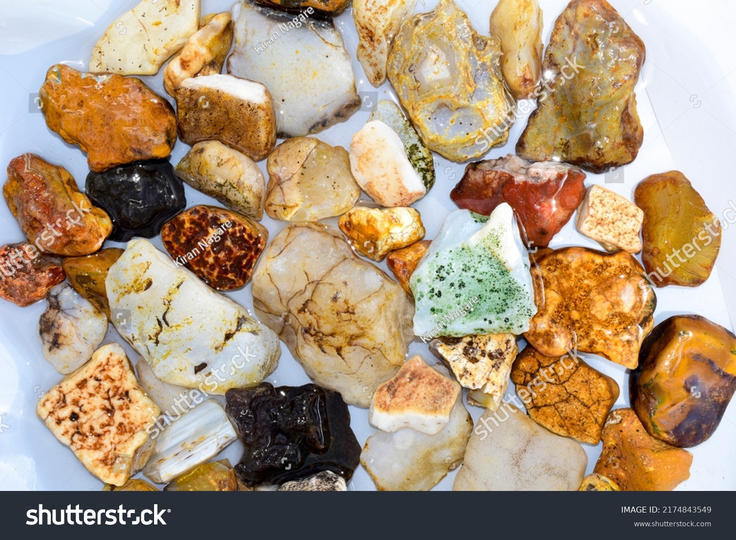 Colorful collection of small river stones on white background, River stones background. #2174843549