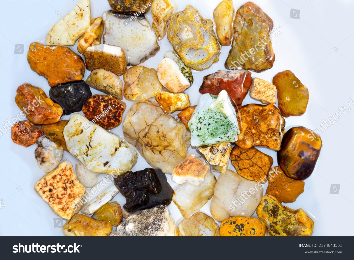 Colorful collection of small river stones on white background, River stones background. #2174843551