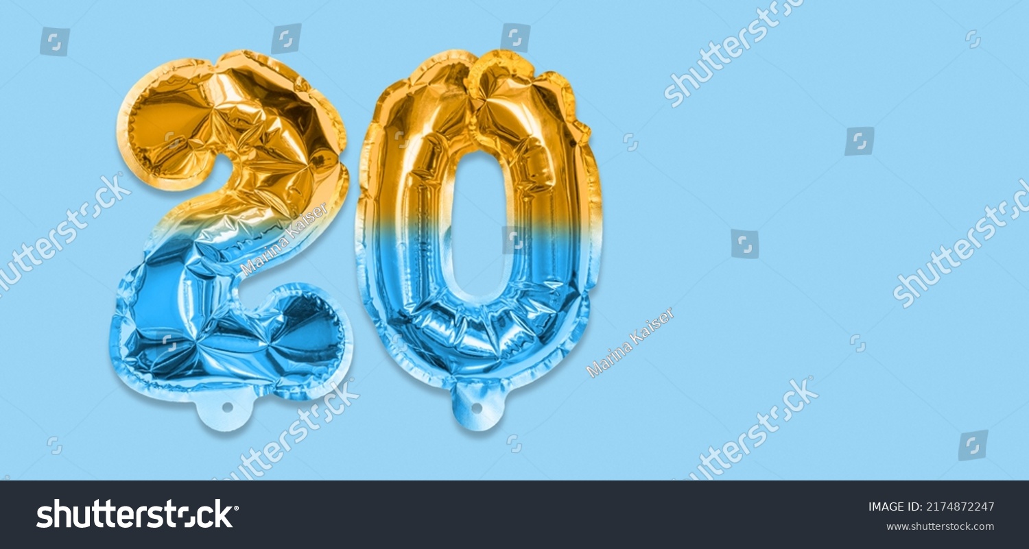 Rainbow foil balloon number, digit twenty on a blue background. Birthday greeting card with inscription 20. Anniversary concept. Top view. Numerical digit. Celebration event, template. Banner. #2174872247