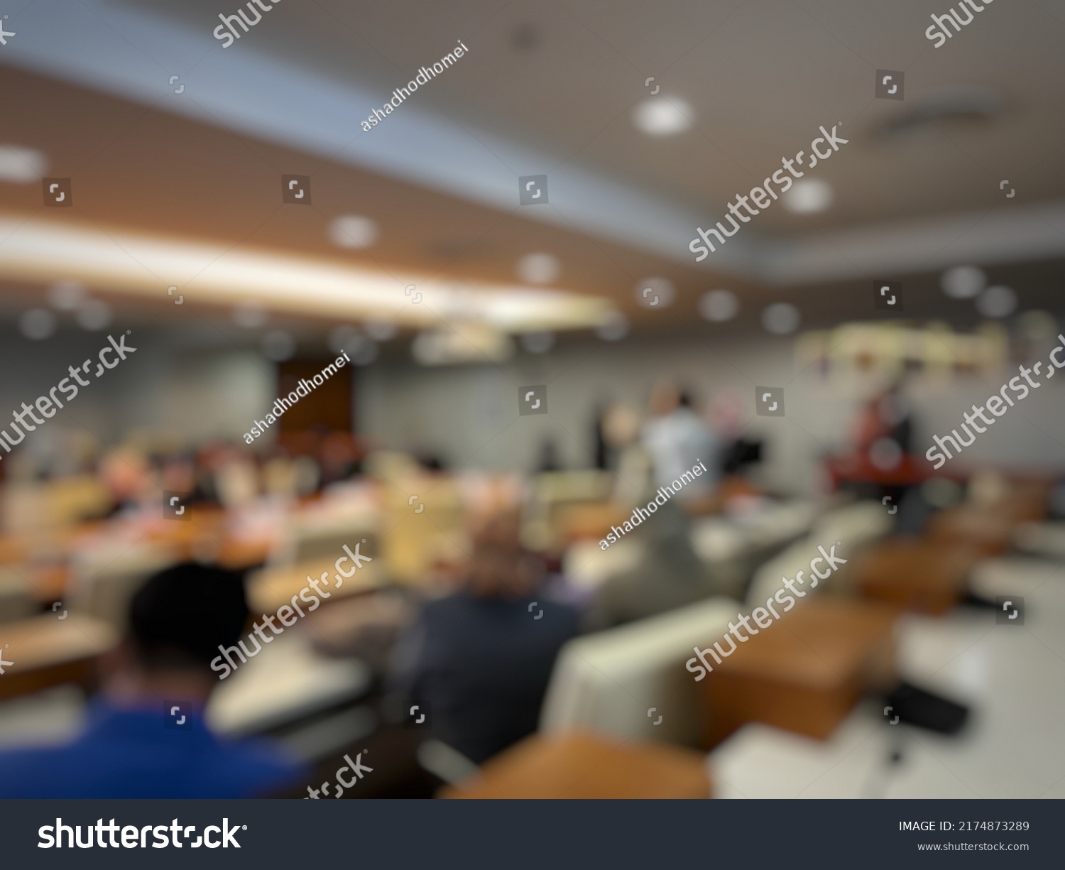 Blurry background of meeting held in a hall #2174873289