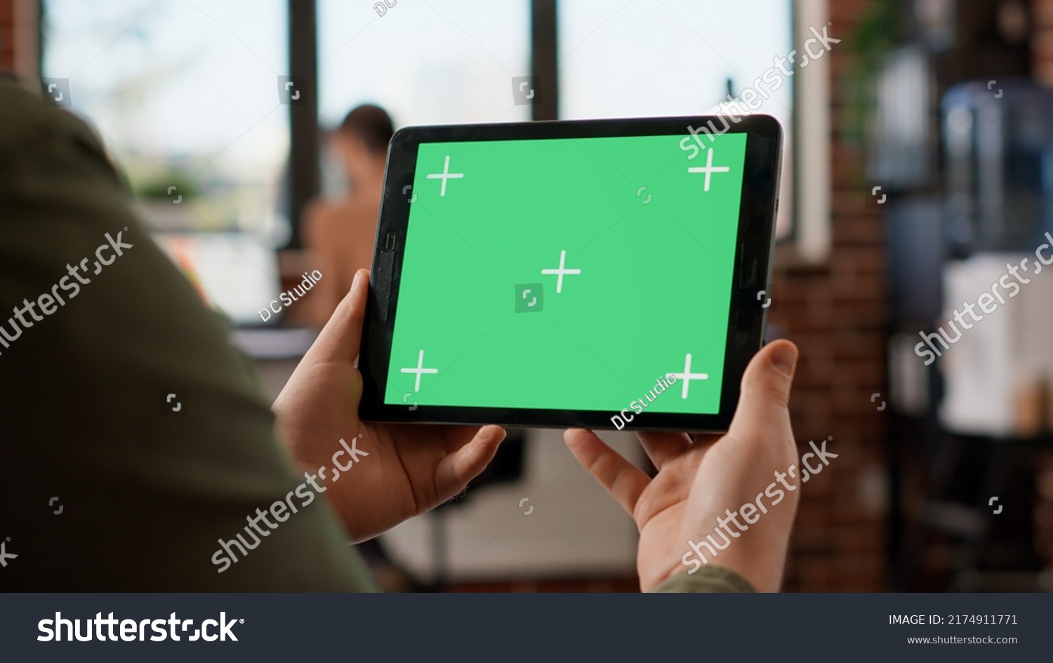 Startup manager looking at horizontal greenscreen on digital tablet, working with blank copyspace template and mockup display. Using isolated chroma key background on gadget. Close up. #2174911771