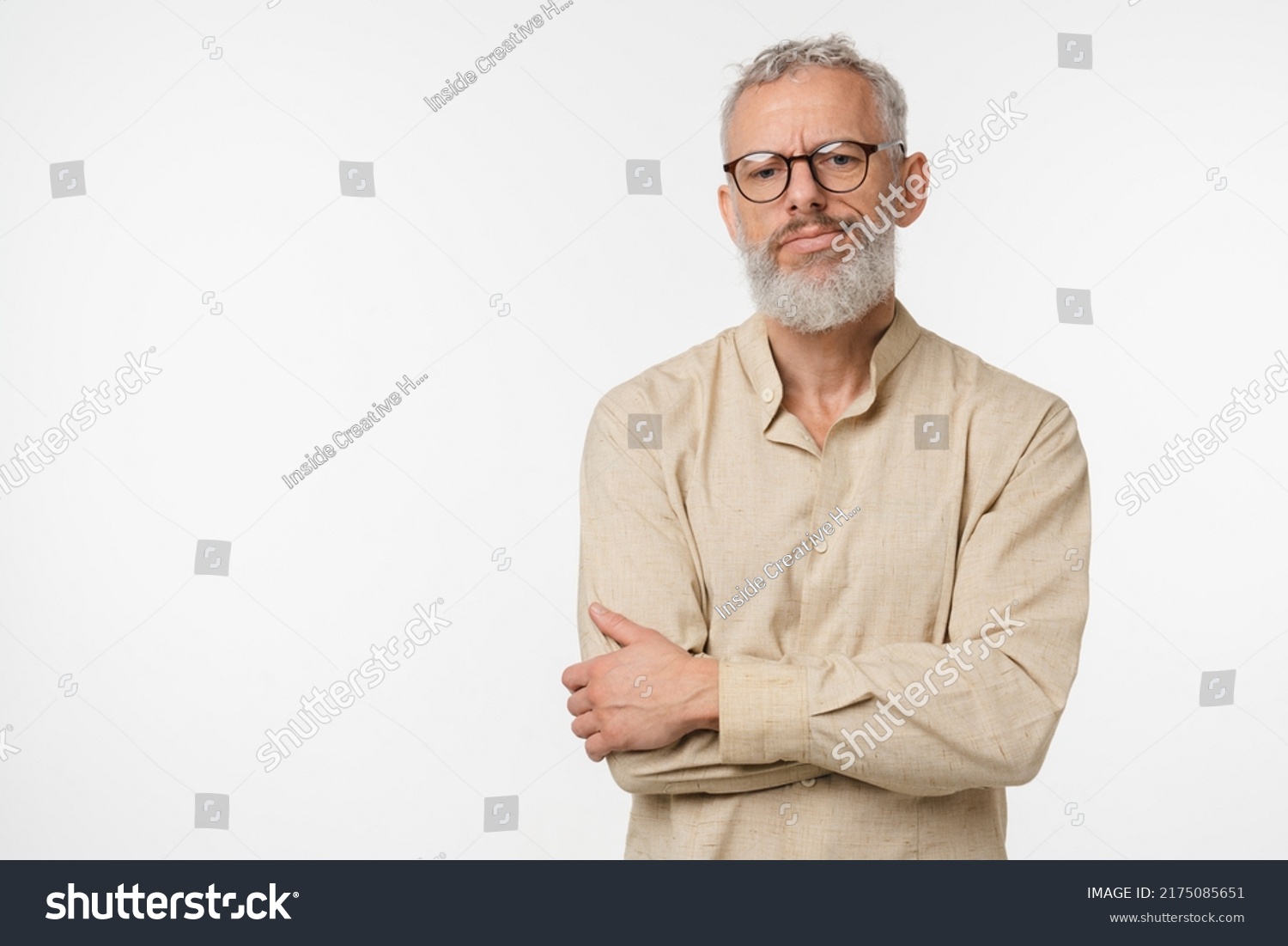Sad offended disappointed caucasian mature middle-aged man in beige shirt and glasses feeling depression guilt negative emotions isolated in white background #2175085651