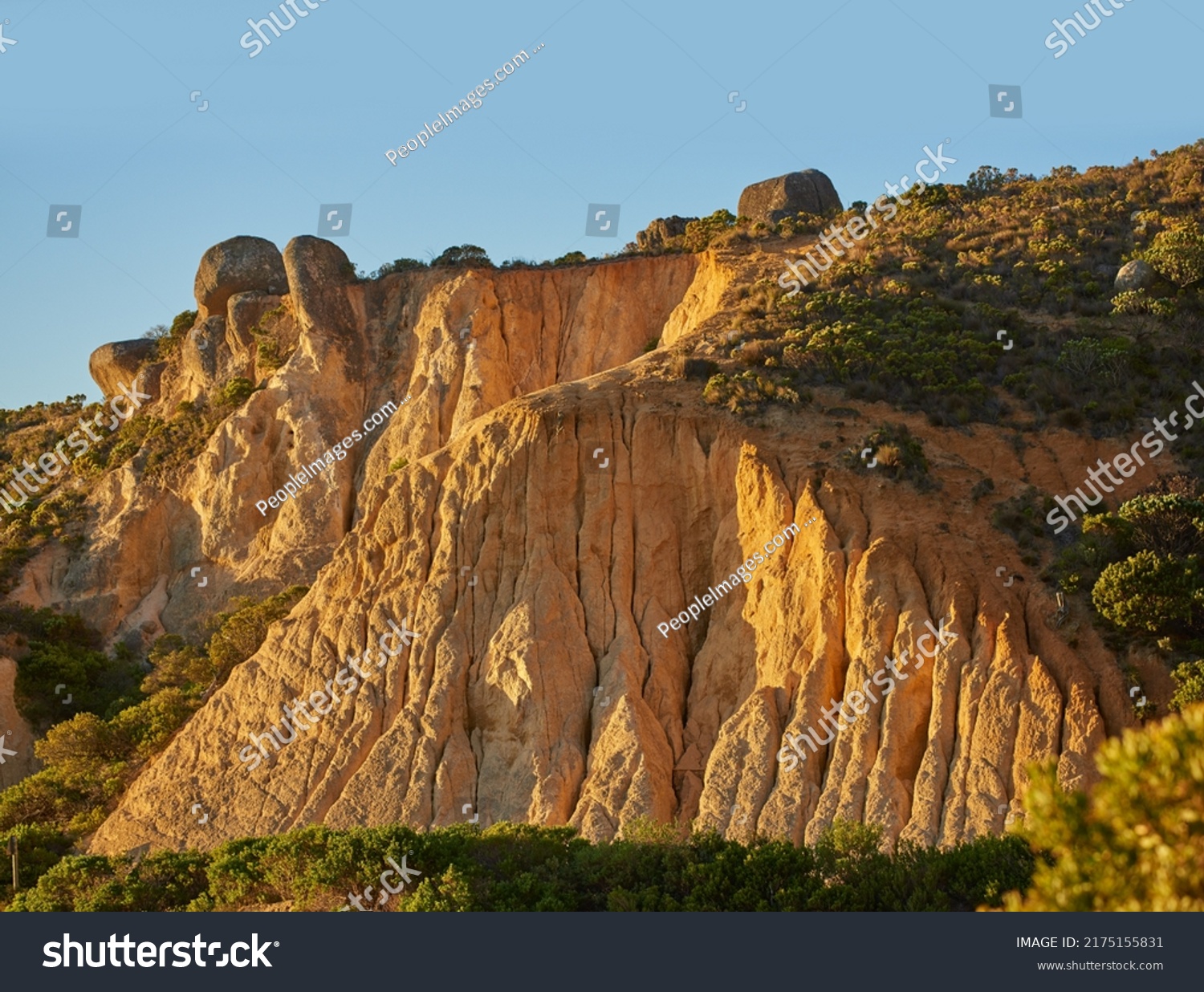 Low angle view of a mountain peak in South Africa. Scenic landscape of a remote hiking location on Lions Head in Cape Town at sunset on a sunny day. Travelling and exploring nature through adventure #2175155831