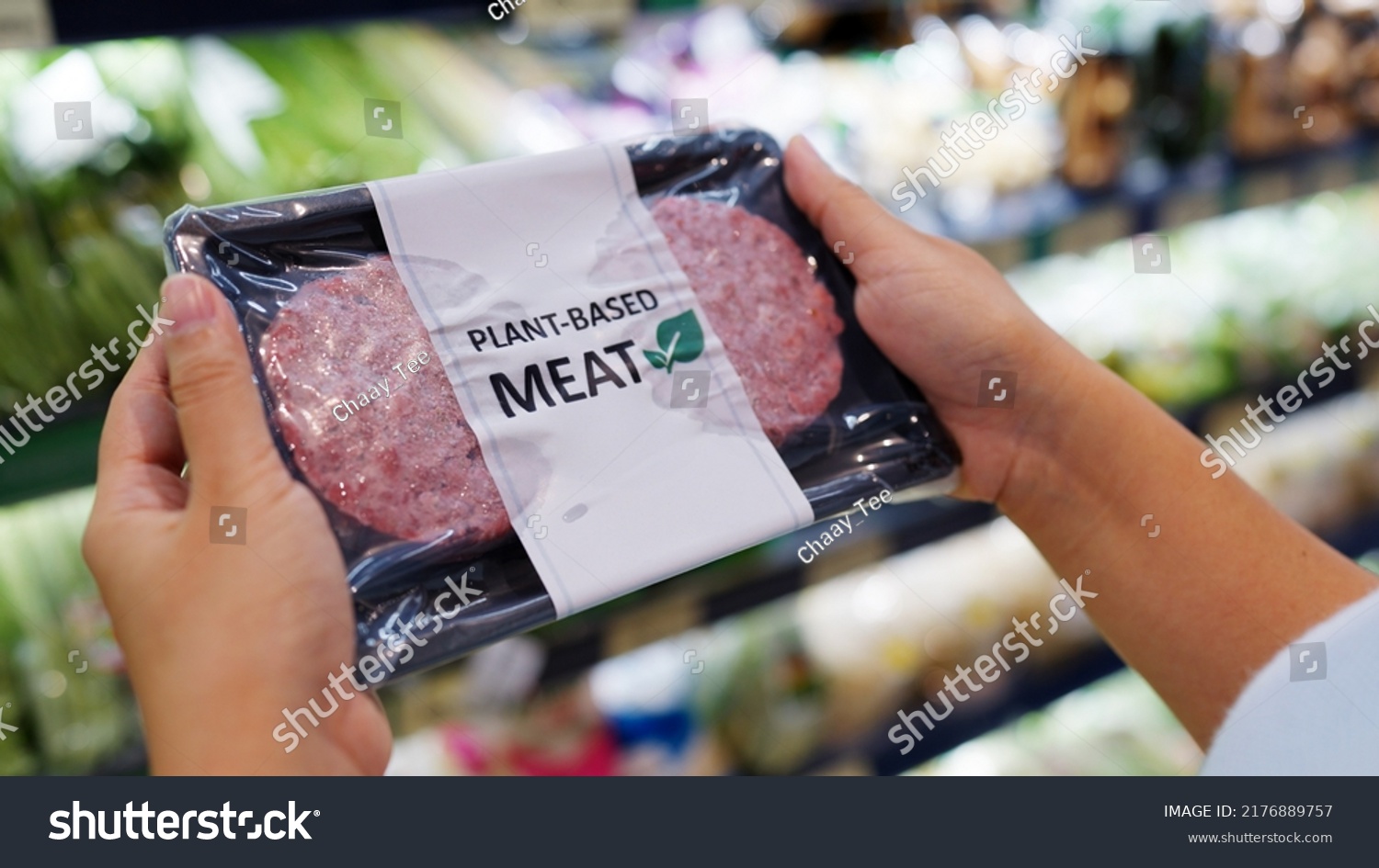 Close-up hand carry choose zero pork soy bean faux peas cutlet gluten free read beyond non-meat lab label. Buy raw fake beef tray in asia store veggie burger patty for health care eat diet meal cook. #2176889757