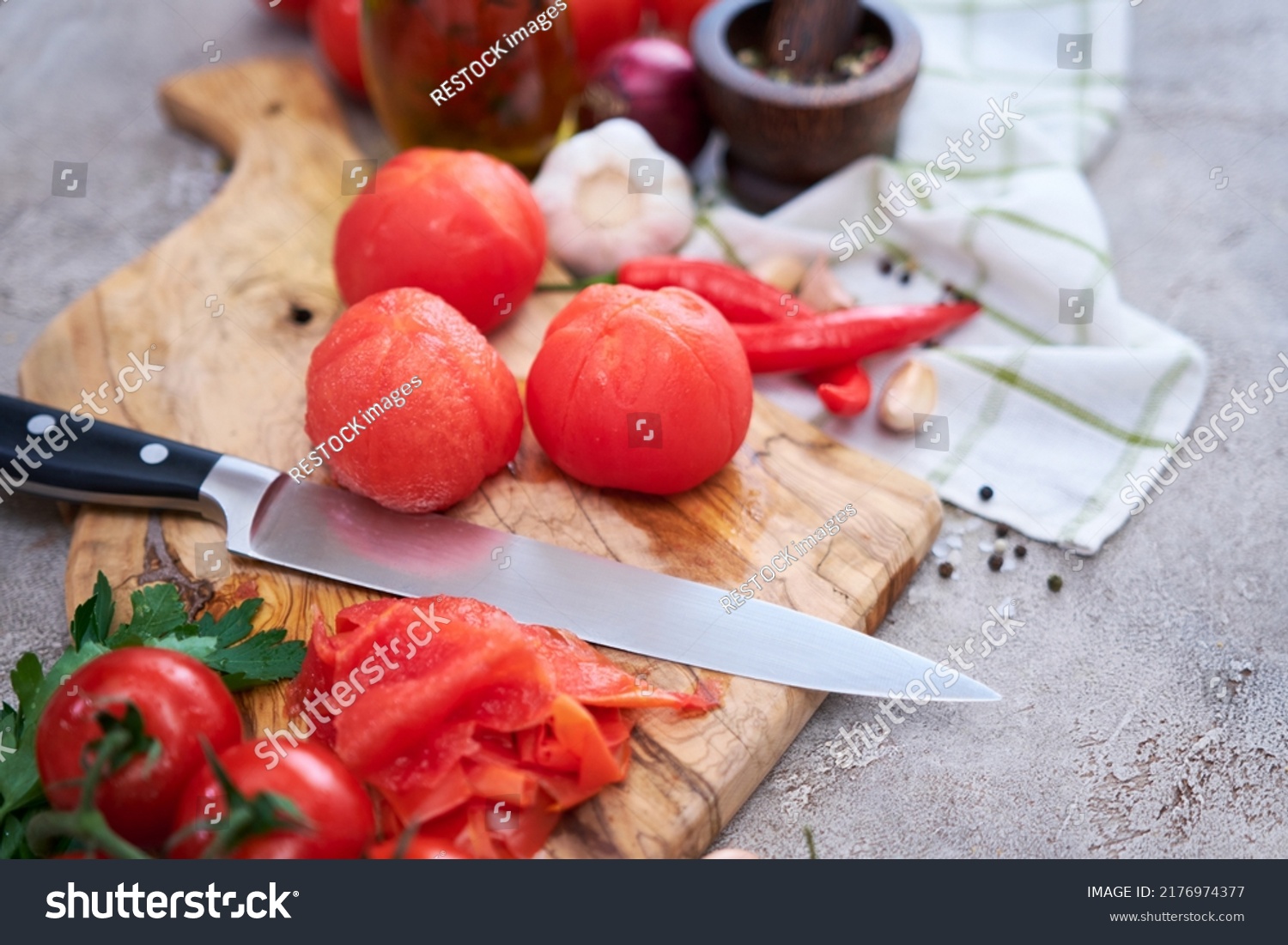 blanched peeled tomatoes on wooden cutting board at domestic kitchen #2176974377