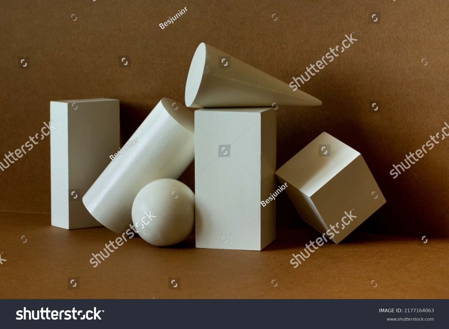White platonic solids figures geometry. Abstract geometrical objects still life composition. Three-dimensional rectangular prism, cylinder pyramid cube, sphere on brown background. #2177164063