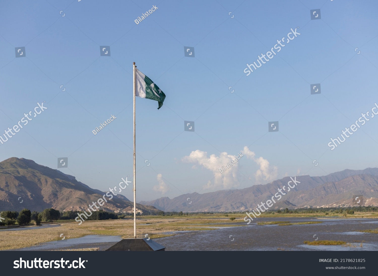 Pakistan flag with a beautiful mountains and river landscape background #2178621825