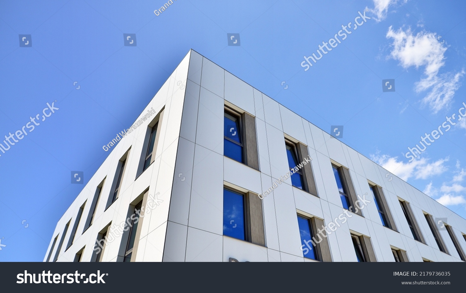 Office building with white aluminum composite panels. Facade wall made of glass and metal. Abstract modern business architecture. #2179736035