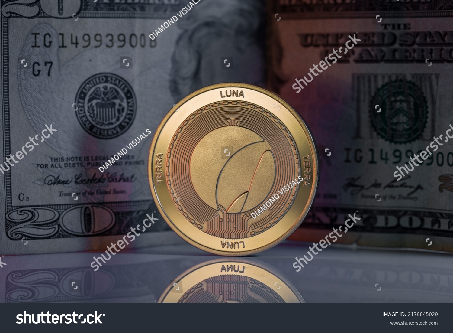 Terra Luna LUNC Cryptocurrency Physical Coin Placed on reflective surface with twenty dollar bill behind. #2179845029