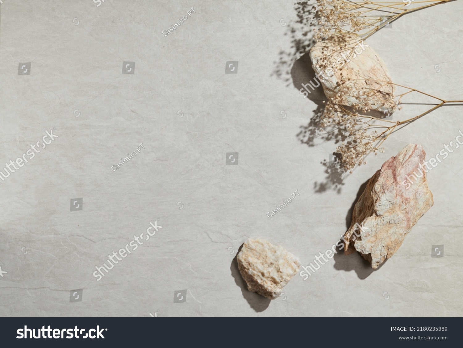 Flatlay minimal natural stone, marble or travertino surface background with stones and dry flowers. Template for showcase, presentations, branding, web desing, posts. #2180235389