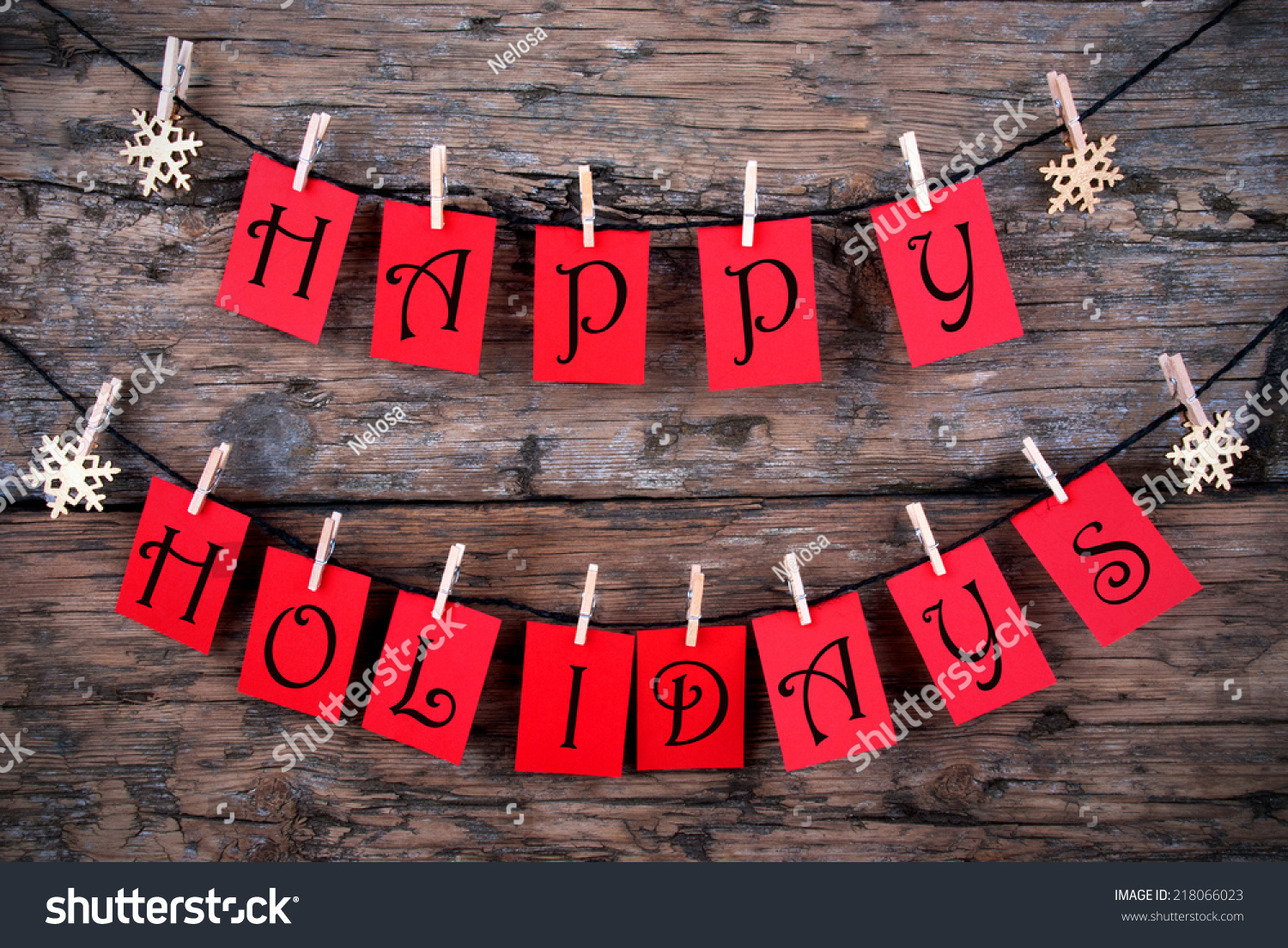 Happy Holidays Greetings on red Tags Hanging on a Line with Snowflakes, Christmas or Winter Background #218066023