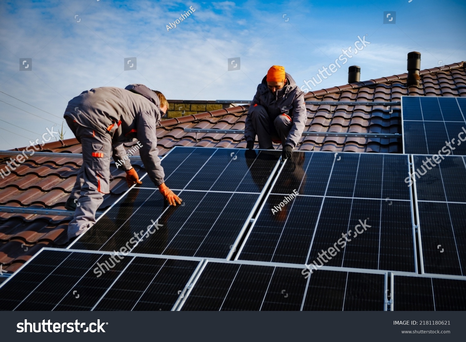Engineers on the roof of house are checking solar cells in the autumn. Technician worker on solar panels
 #2181180621
