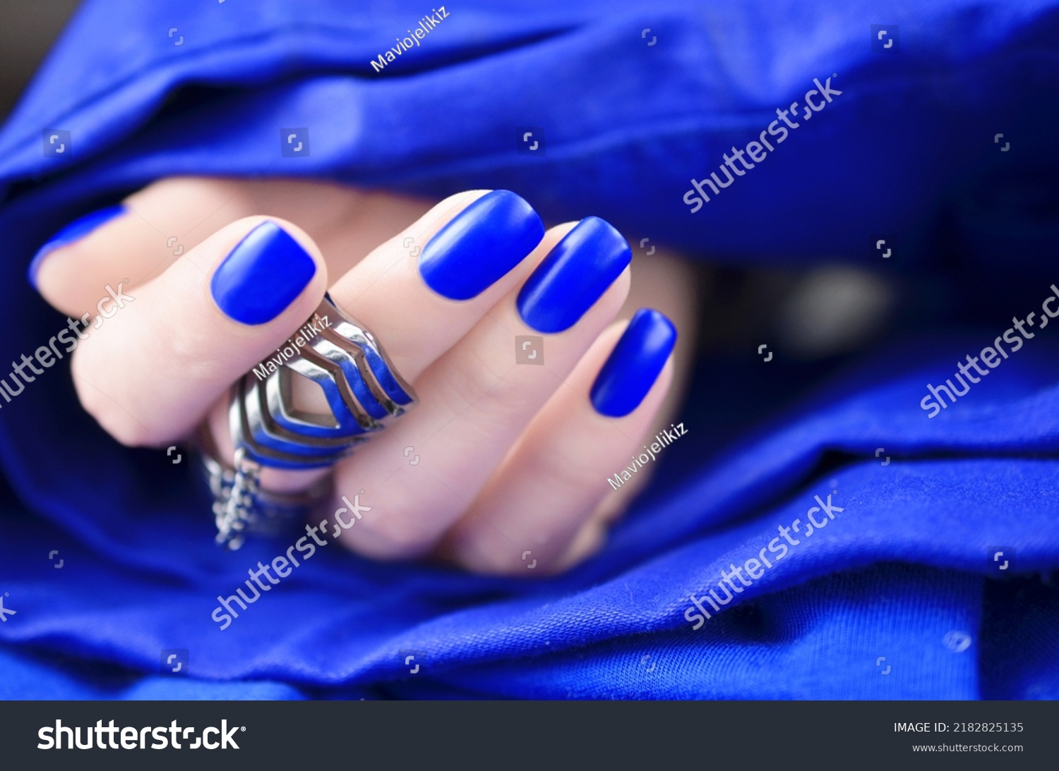 Matte cobalt blue manicured nails isolated on white background. #2182825135