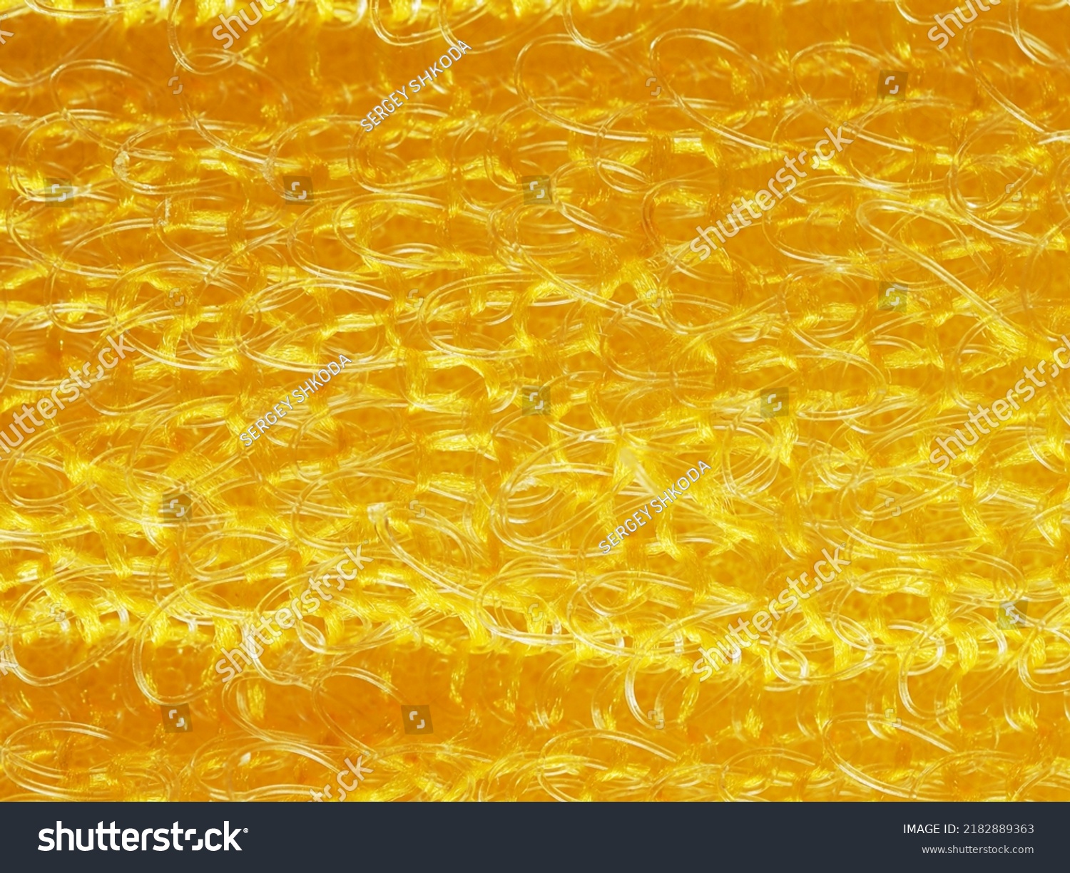 close up, background, texture, large horizontal banner. heterogeneous surface structure bright saturated yellow sponge for washing dishes, kitchen, bath. full depth of field. high resolution photo #2182889363