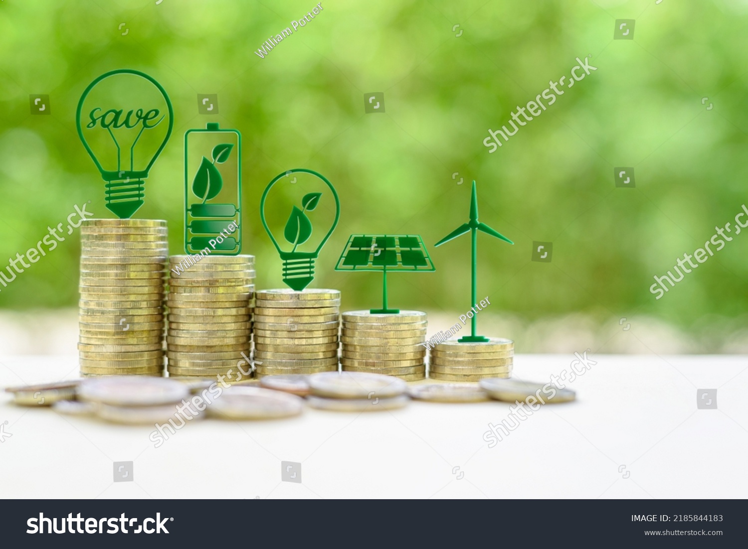 Alternative or renewable energy financing program, financial concept : Green eco-friendly or sustainable energy symbols atop five coin stacks e.g a light bulb, a rechargeable battery, solar cell panel #2185844183