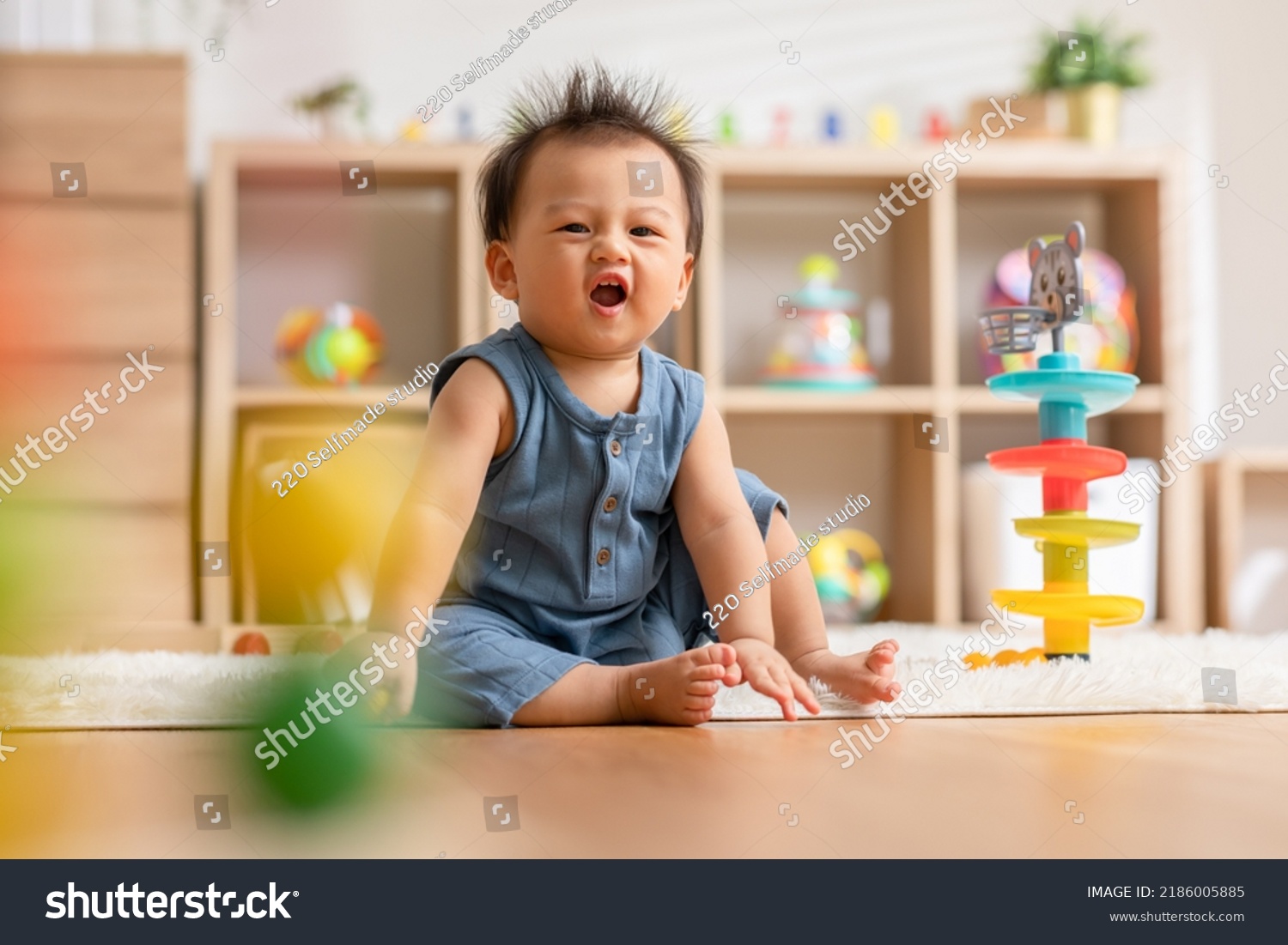 Cute Asian baby playing educational toys to learning and develop skill at home. Adorable cheerful baby toddler enjoy with toys in Nursery. Development skill in baby concept #2186005885