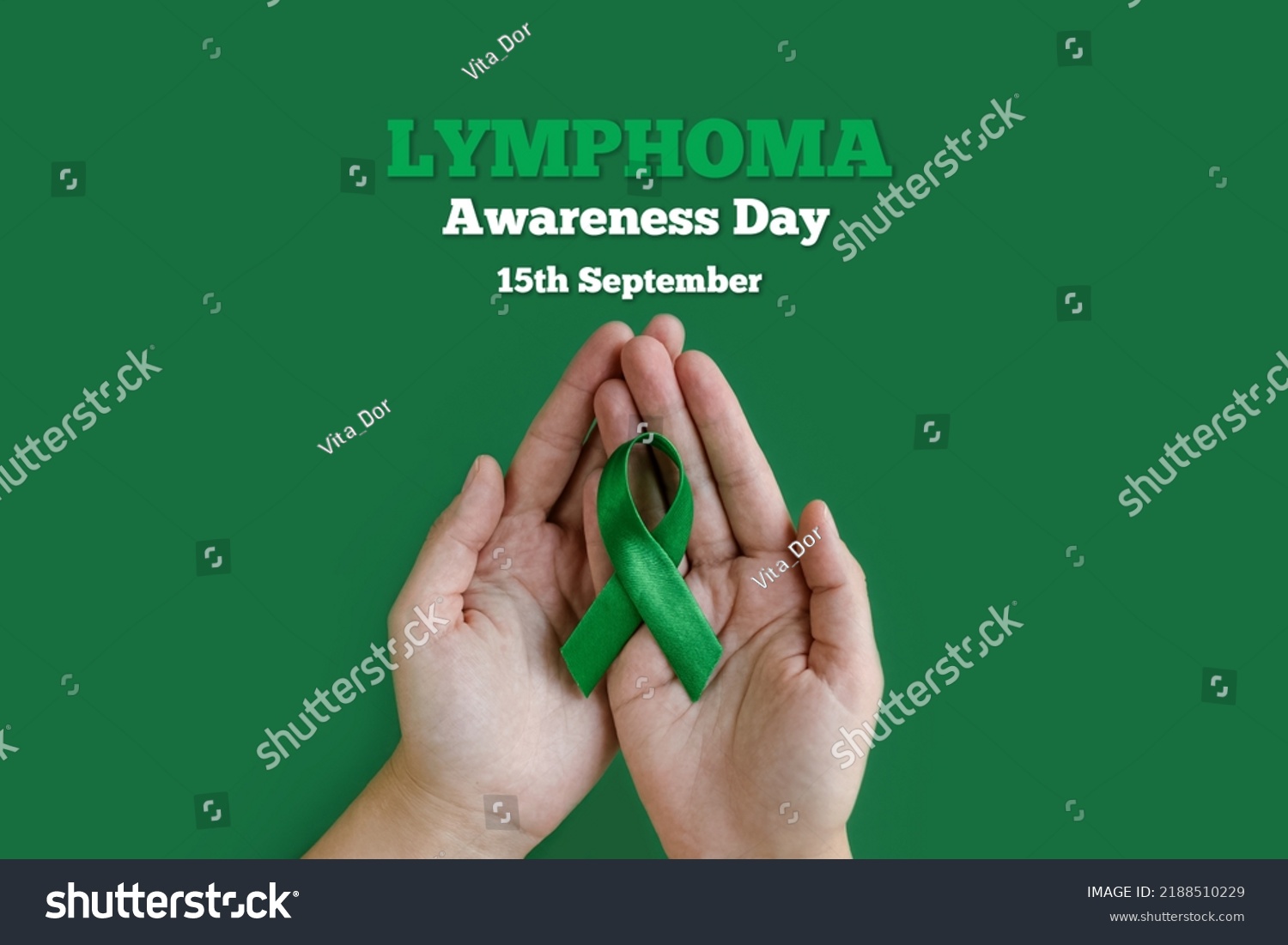 Adult hands holds green ribbon on green background. World lymphoma awareness day. September 15. Cancer and Lymphoma Awareness month #2188510229