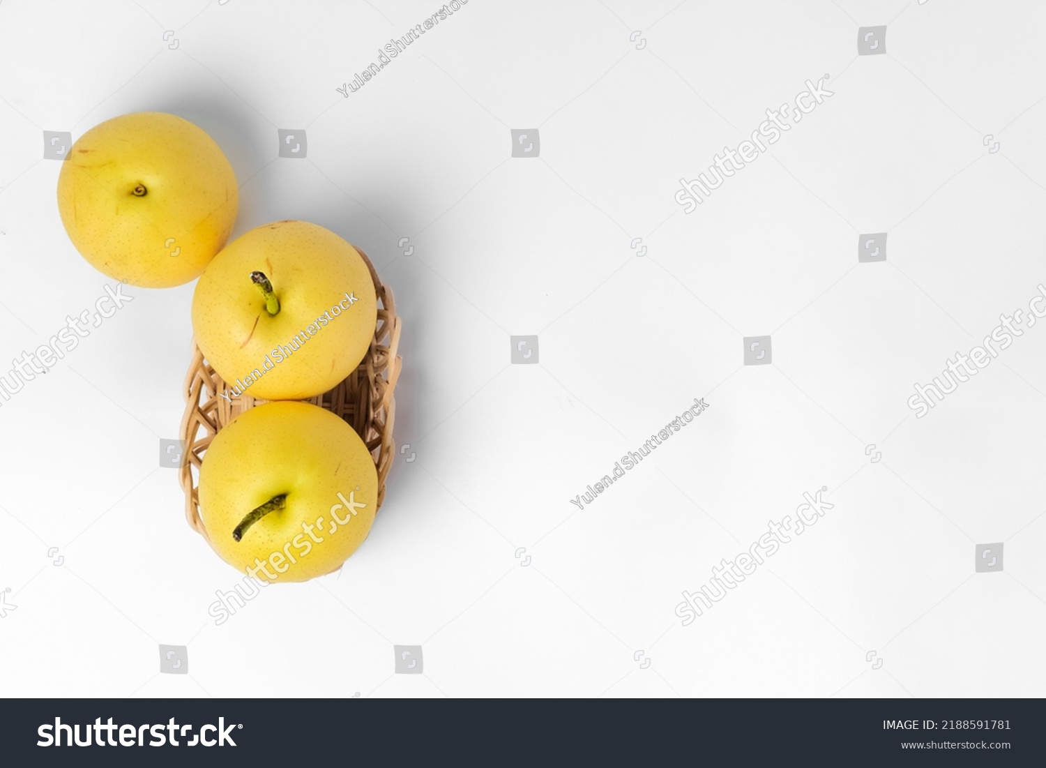 Some asian pears in a basket on a white background, copy space #2188591781