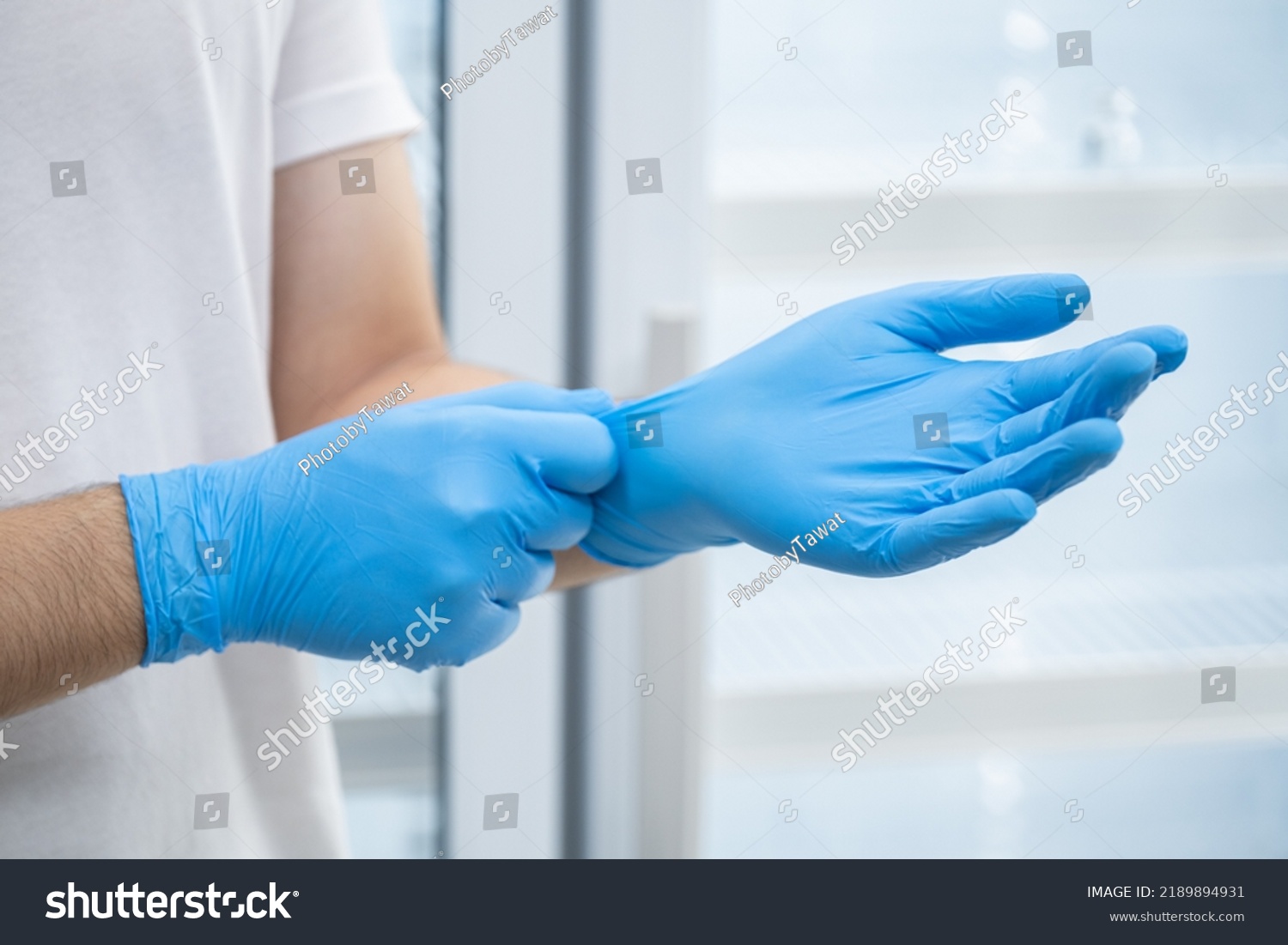 Doctor wearing blue nitrile gloves (select focus) #2189894931
