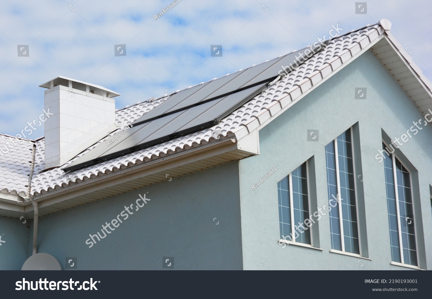 White roof house for energy saving. Close up on modern house energy efficiency white roof with solar water heating panels. White Roof Coatings.
 #2190193001