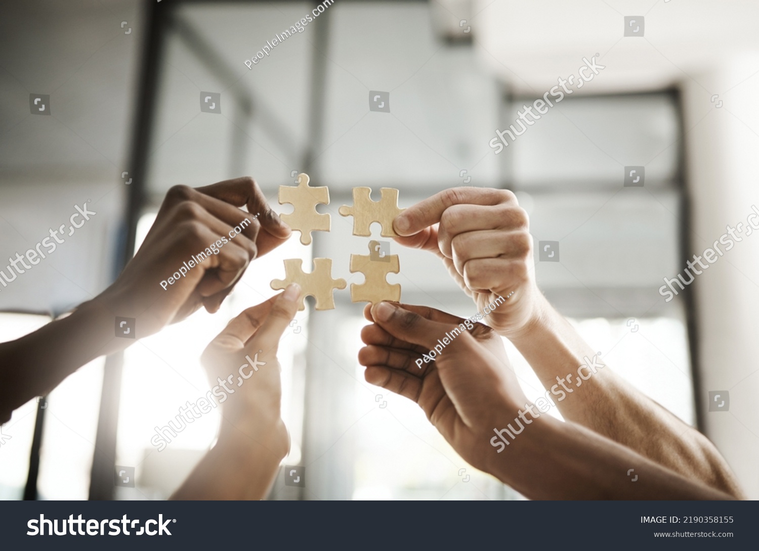 Business people hands with puzzle showing solution, problem solving and teamwork. Smart group or team activity completing, finishing a task project or assignment in difficult challenging work crisis #2190358155