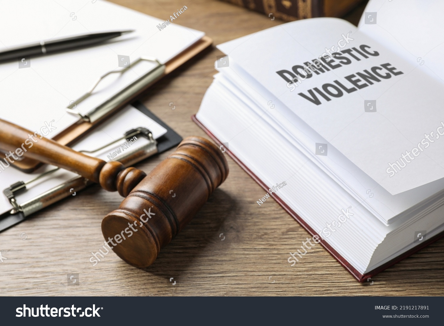 Wooden gavel and law book on wooden table. Protection from domestic violence #2191217891