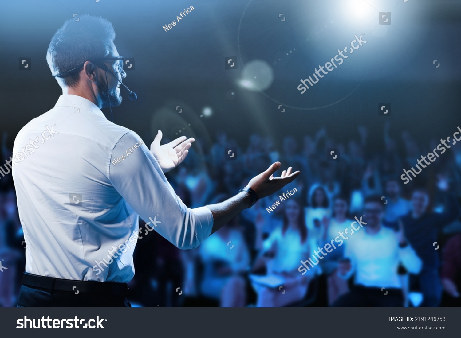 Motivational speaker with headset performing on stage #2191246753