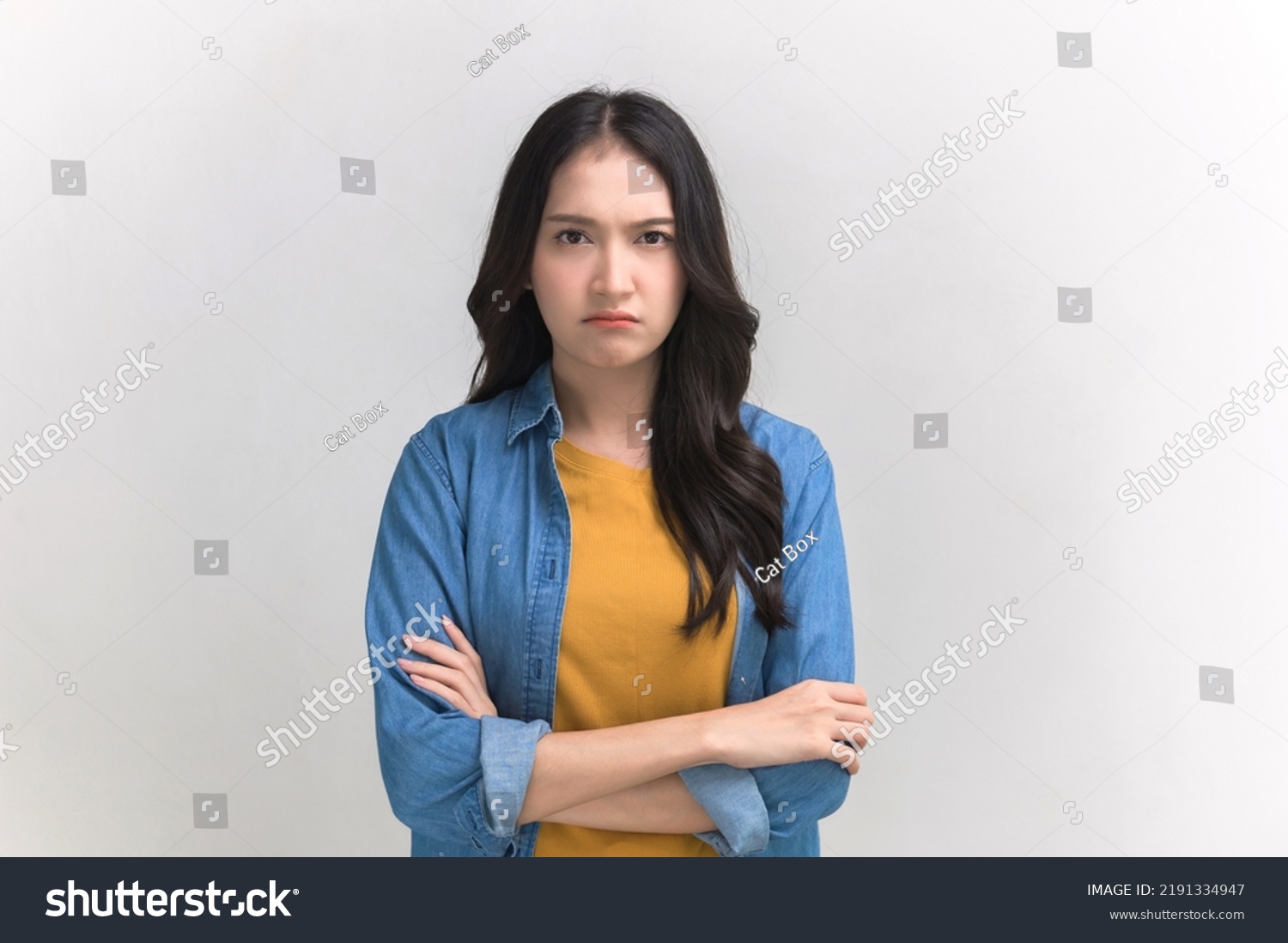 Studio portrait photo of young Asian woman with anger face expression on white background. Young woman emotion face expression portrait concept. #2191334947