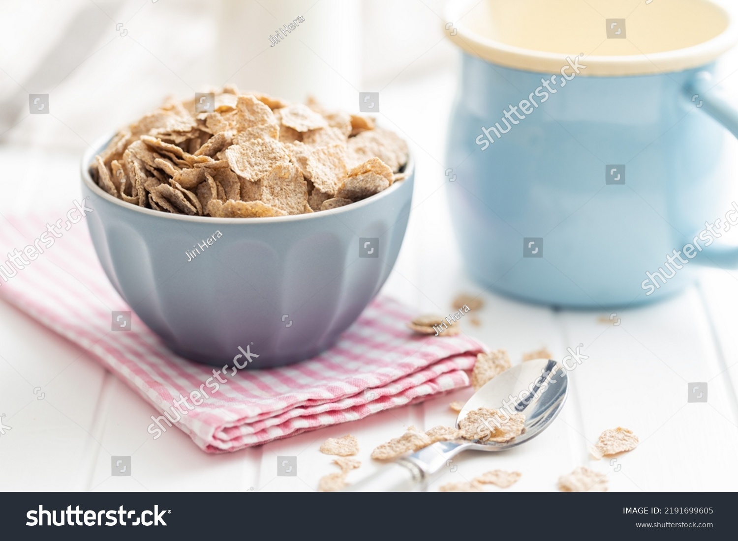 Whole grain cereal flakes. Wholegrain breakfast cereals in bowl on a kitchen table. #2191699605